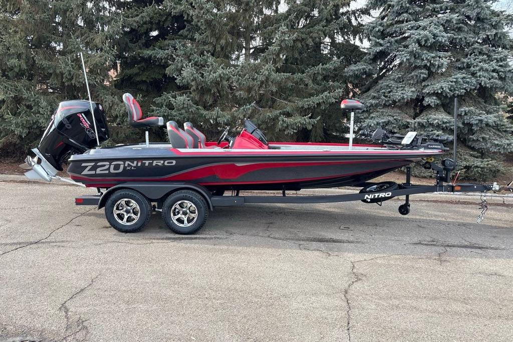 2026 Nitro Z20 XL Pro boat on trailer, parked outdoors near trees.