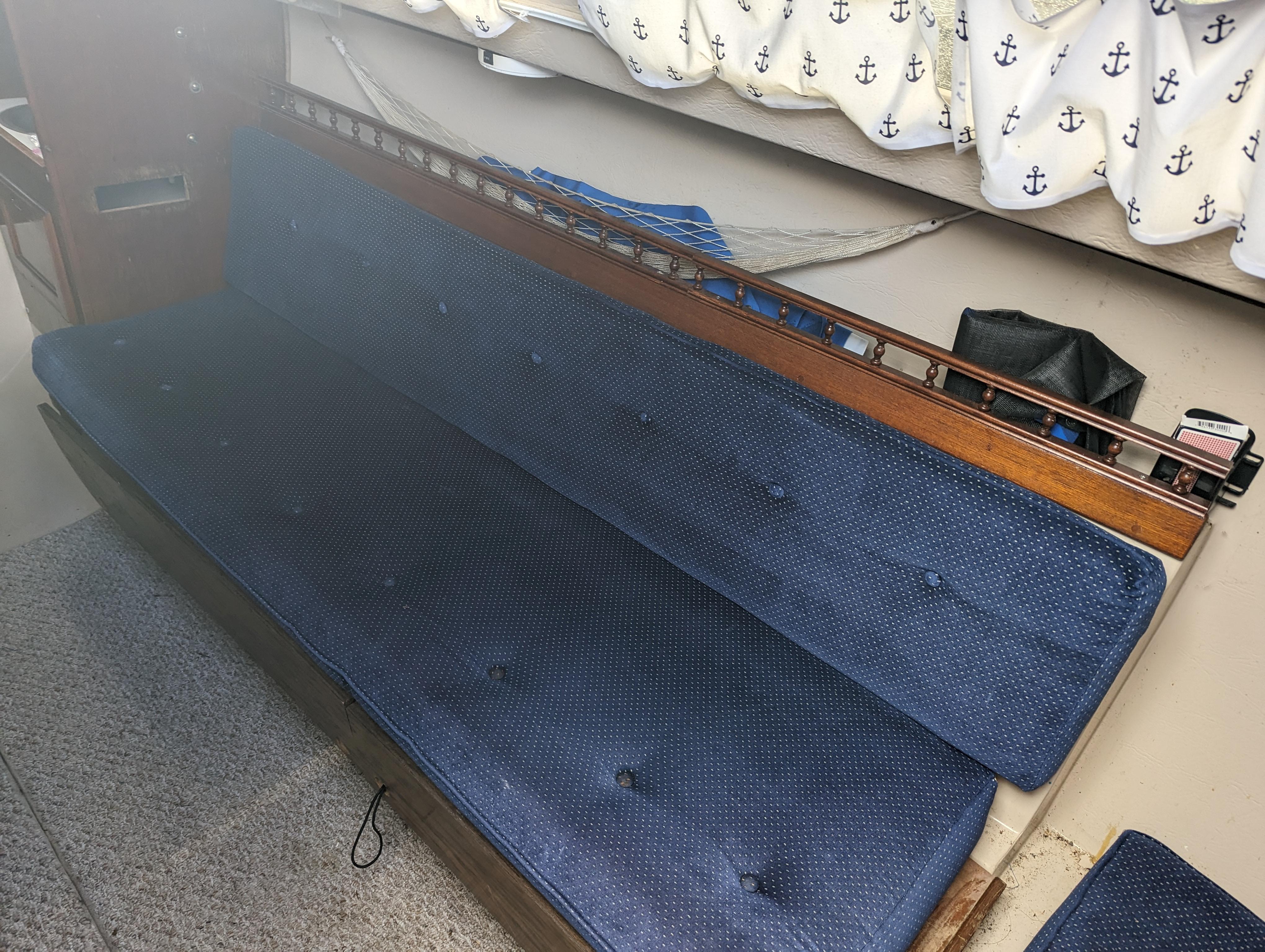 Interior seating of a 1987 Catalina 25 sailboat with blue cushions.