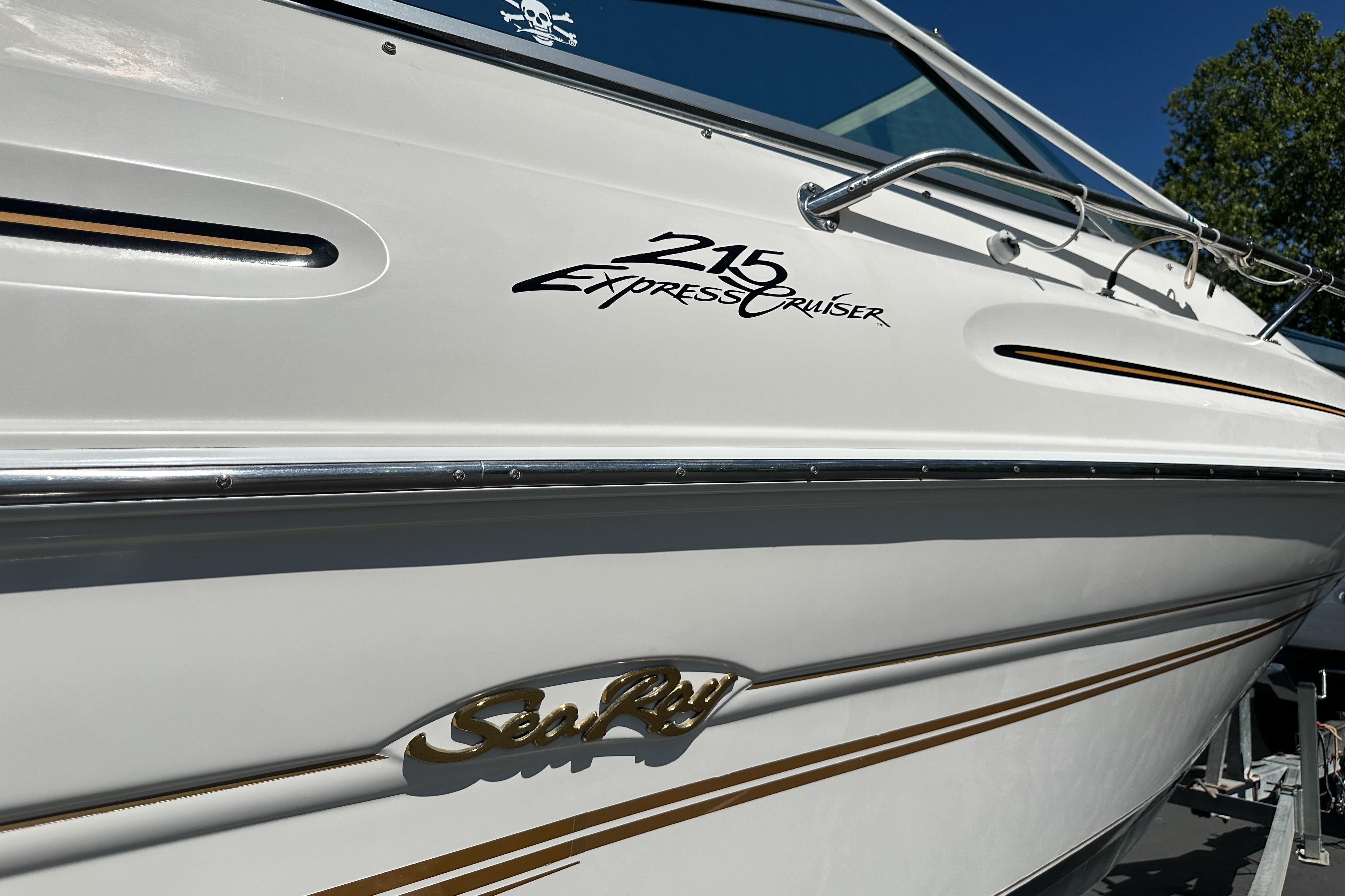 1998 Sea Ray 215 Express Cruiser boat with sleek white exterior and elegant branding.