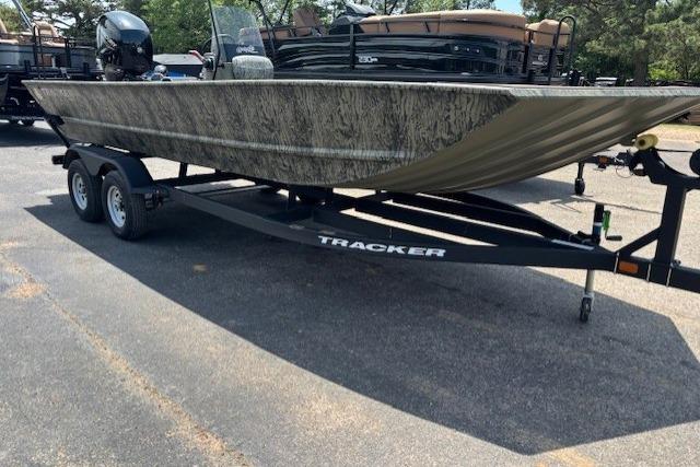 2026 Tracker Grizzly 2072 CC boat on trailer, parked outdoors.