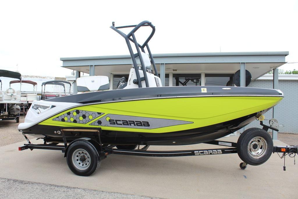 2017 Scarab 195 boat in vibrant lime green on trailer, side view.