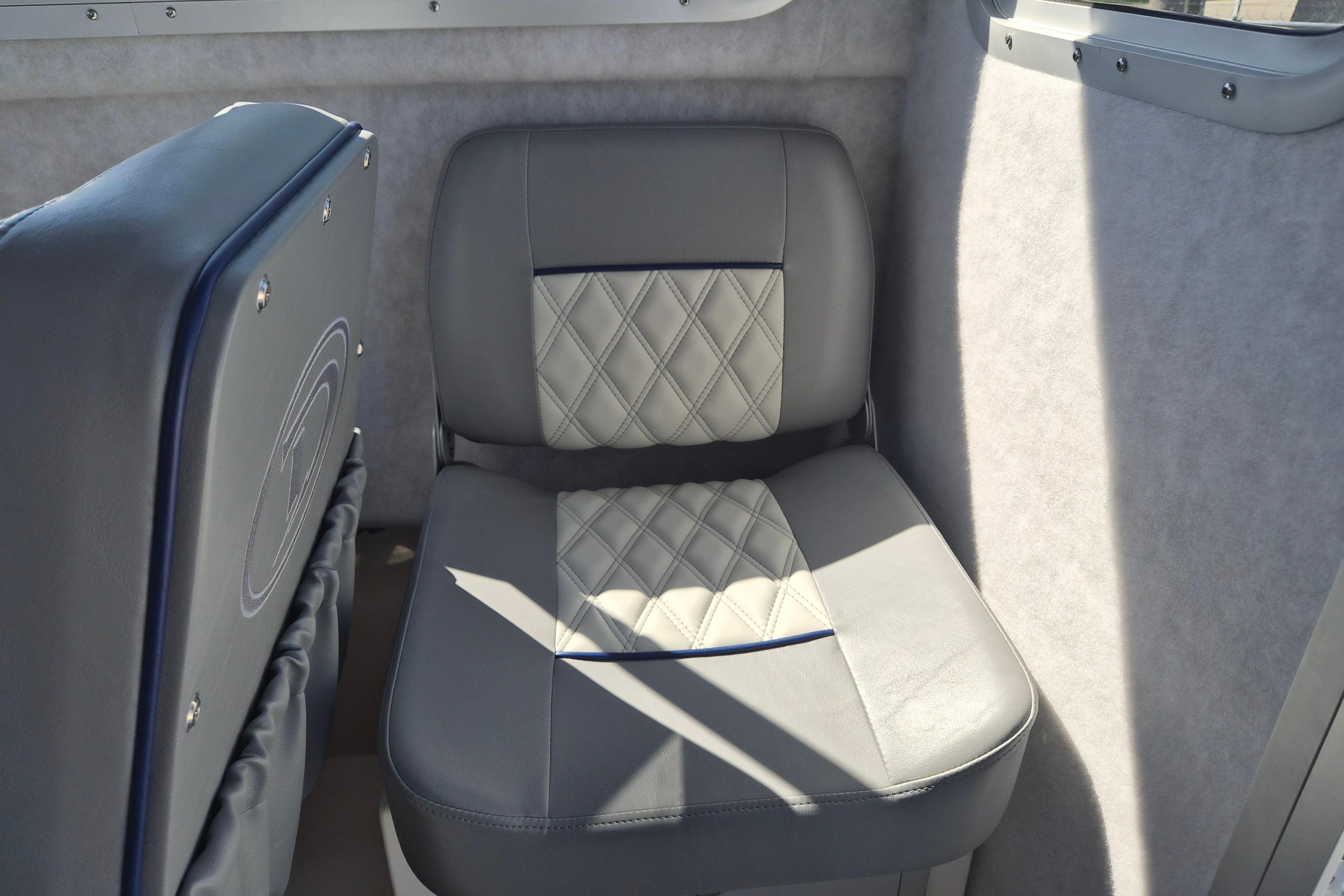 Gray leather seat in 2026 Defiance Admiral 220 EX boat interior.