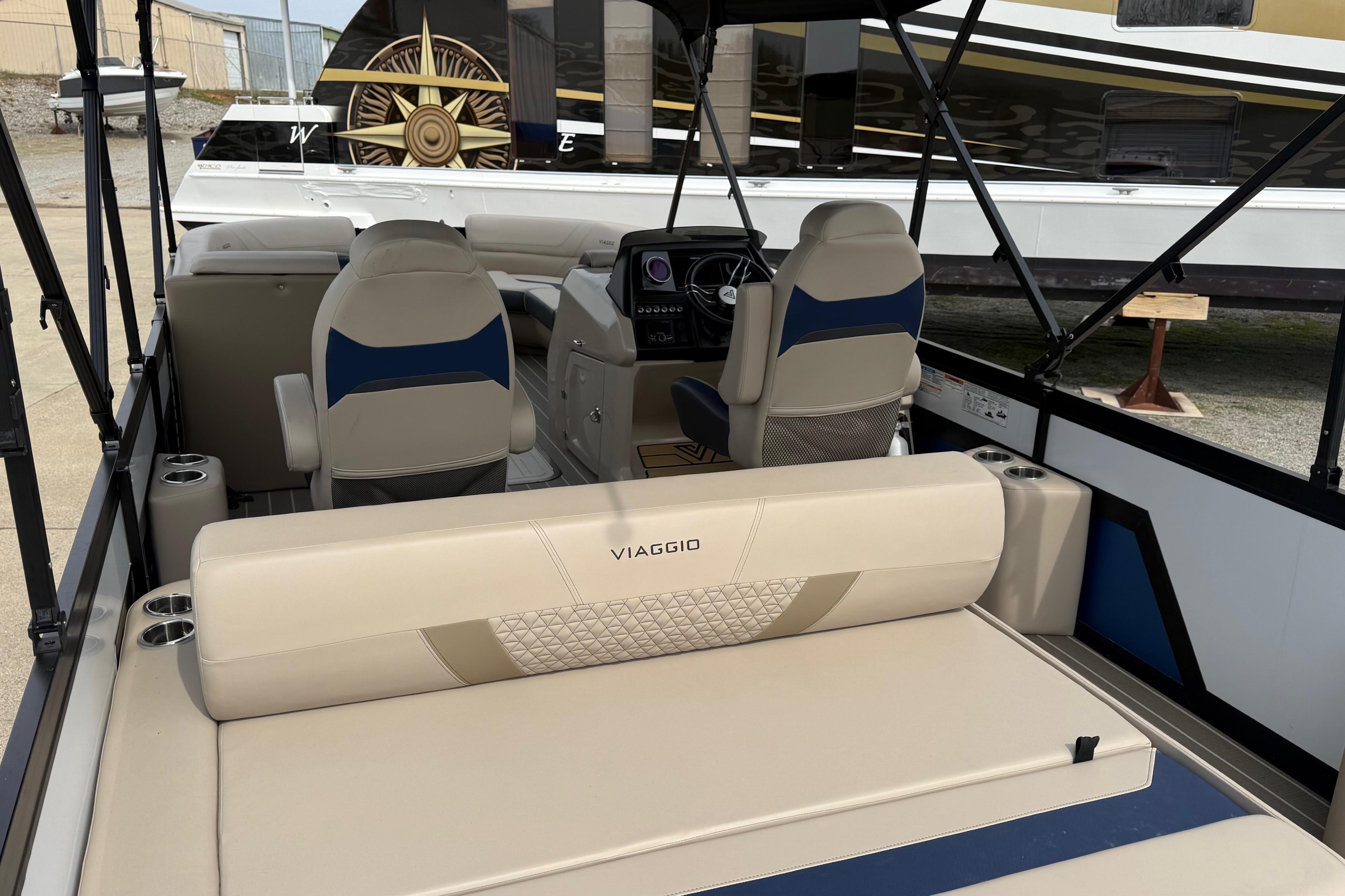 Interior of 2022 Viaggio Diamante S 26 boat with beige seating and modern dashboard.