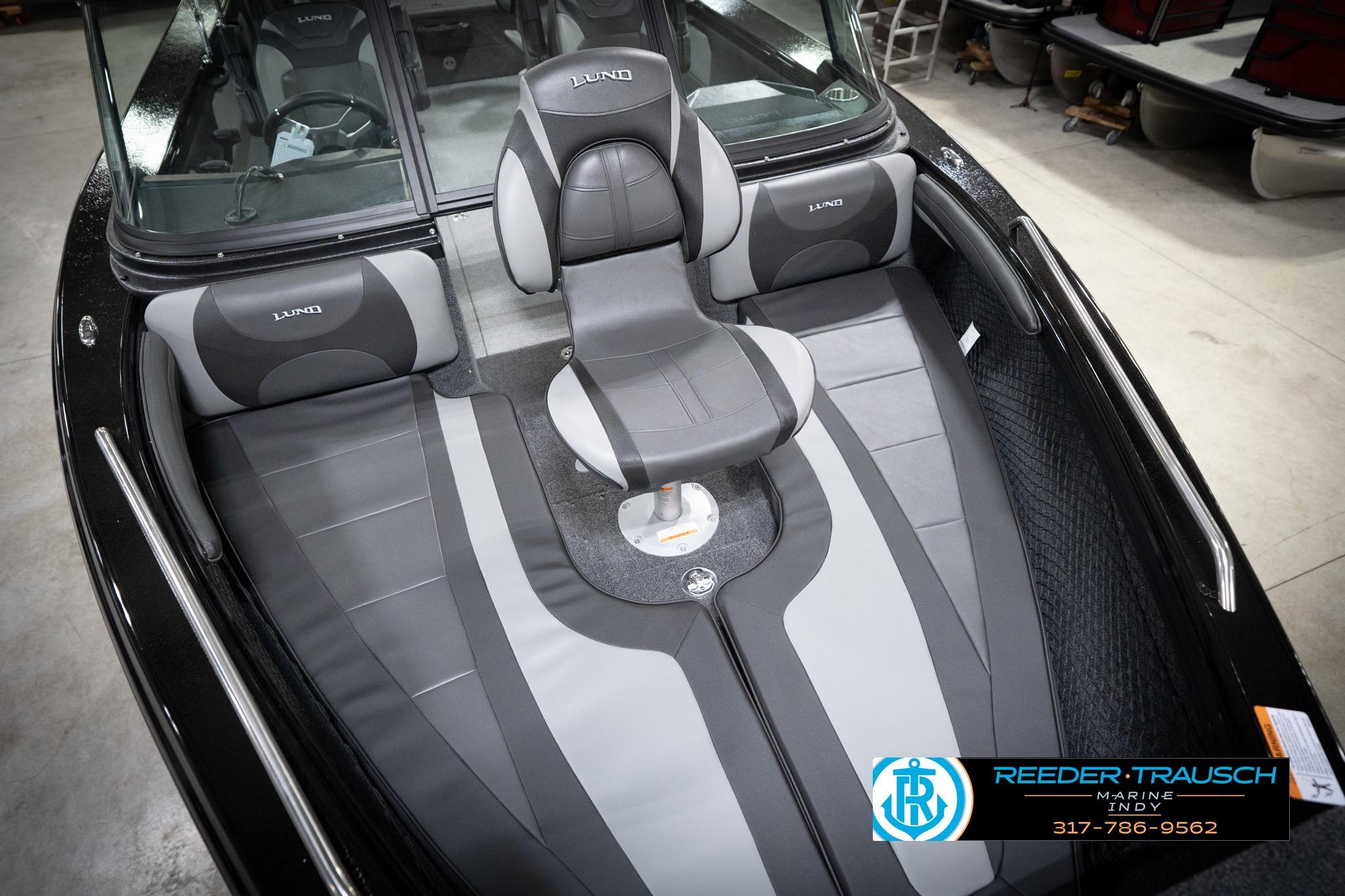 2026 Lund 2275 Baron boat interior with gray seating and steering wheel.