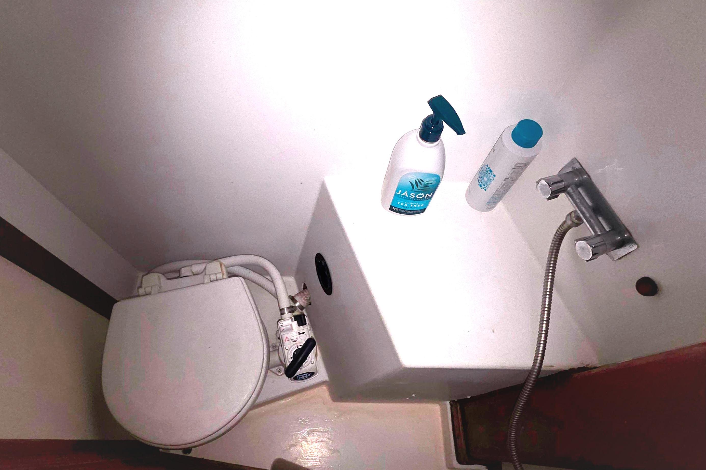 Interior of 1978 Islander Freeport 41 boat bathroom with toiletries and plumbing fixtures.