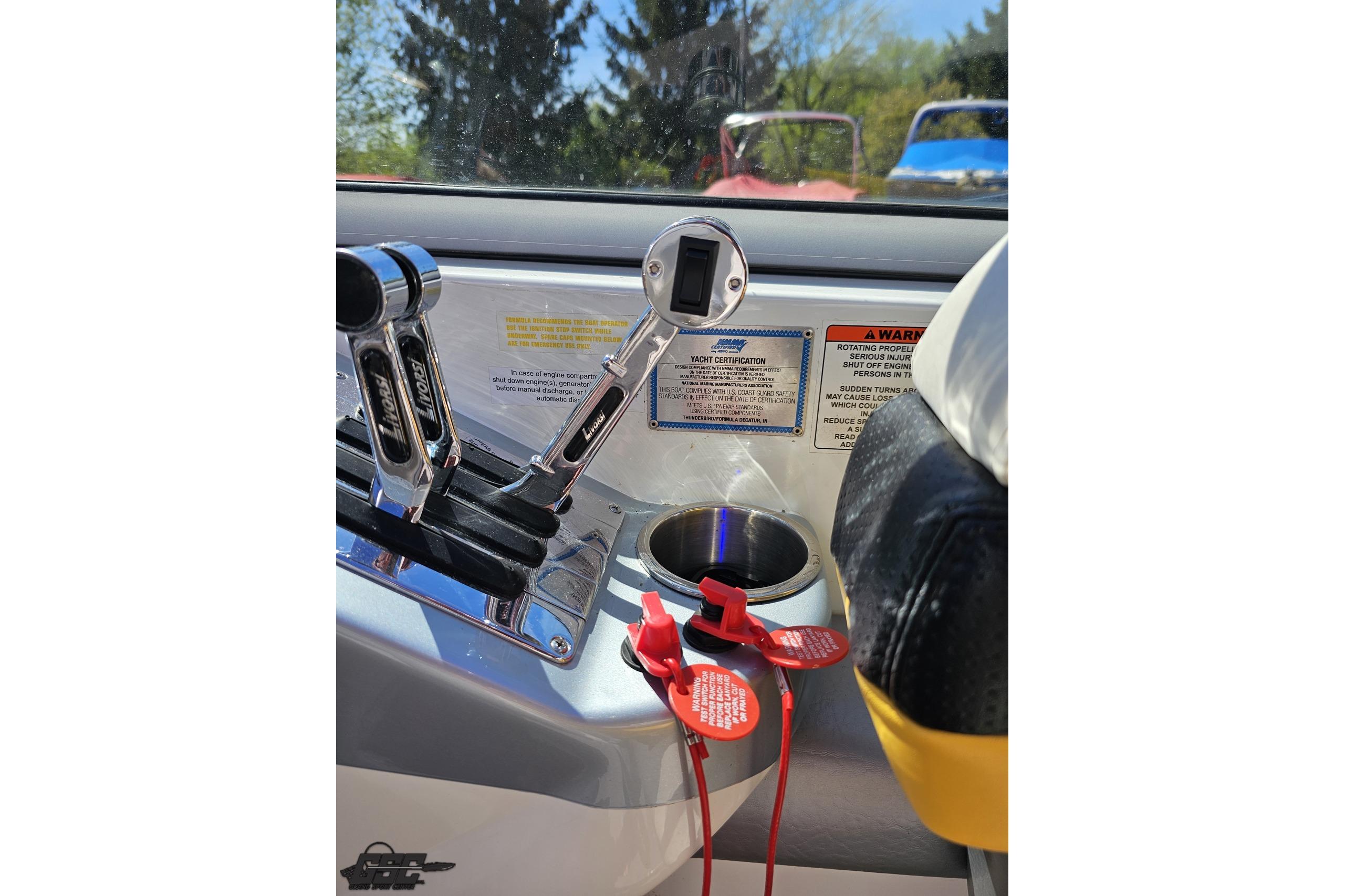 2014 Formula 292 FASTech boat controls with warning labels and cup holder.