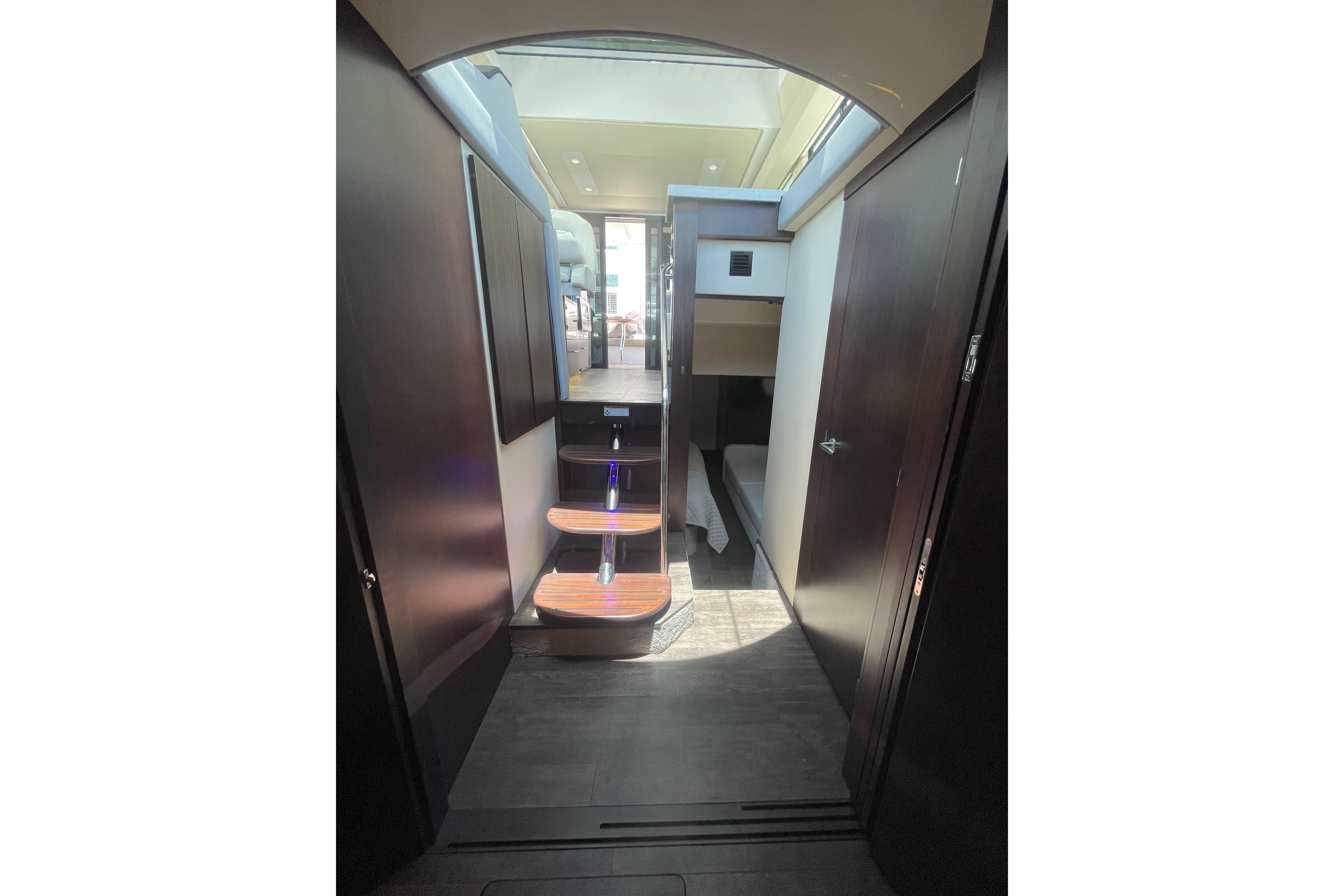 Interior view of 2020 Regal 42 Grande Coupe yacht with modern staircase and sleek design.