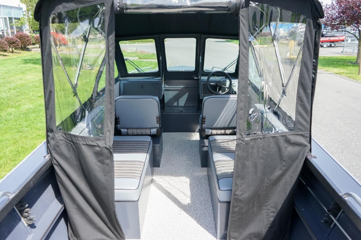Interior view of 2026 Alumaweld X202 Stryker boat with seating and steering wheel.