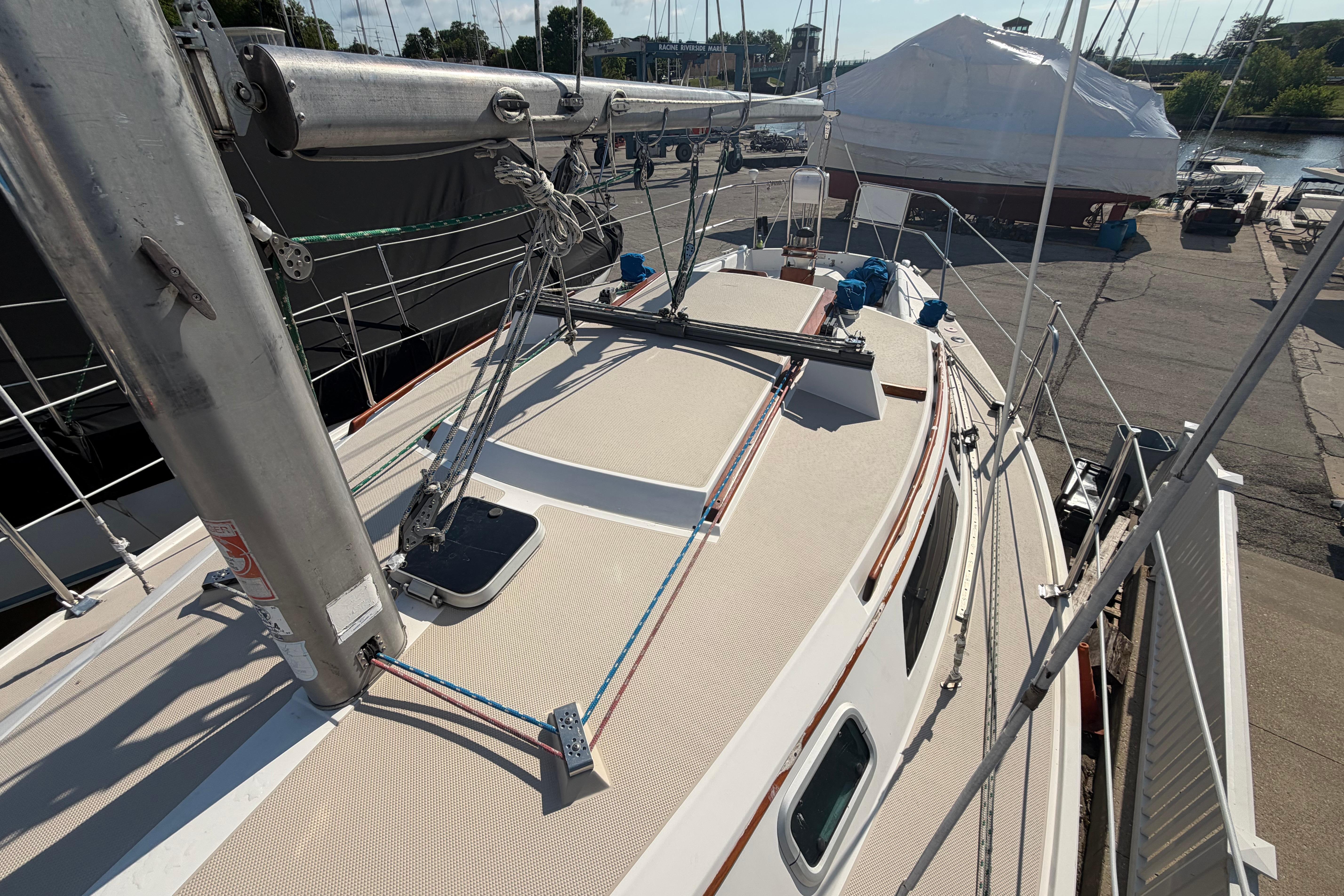 1988 Catalina 30 MkII sailboat deck view at marina, showcasing mast and rigging.
