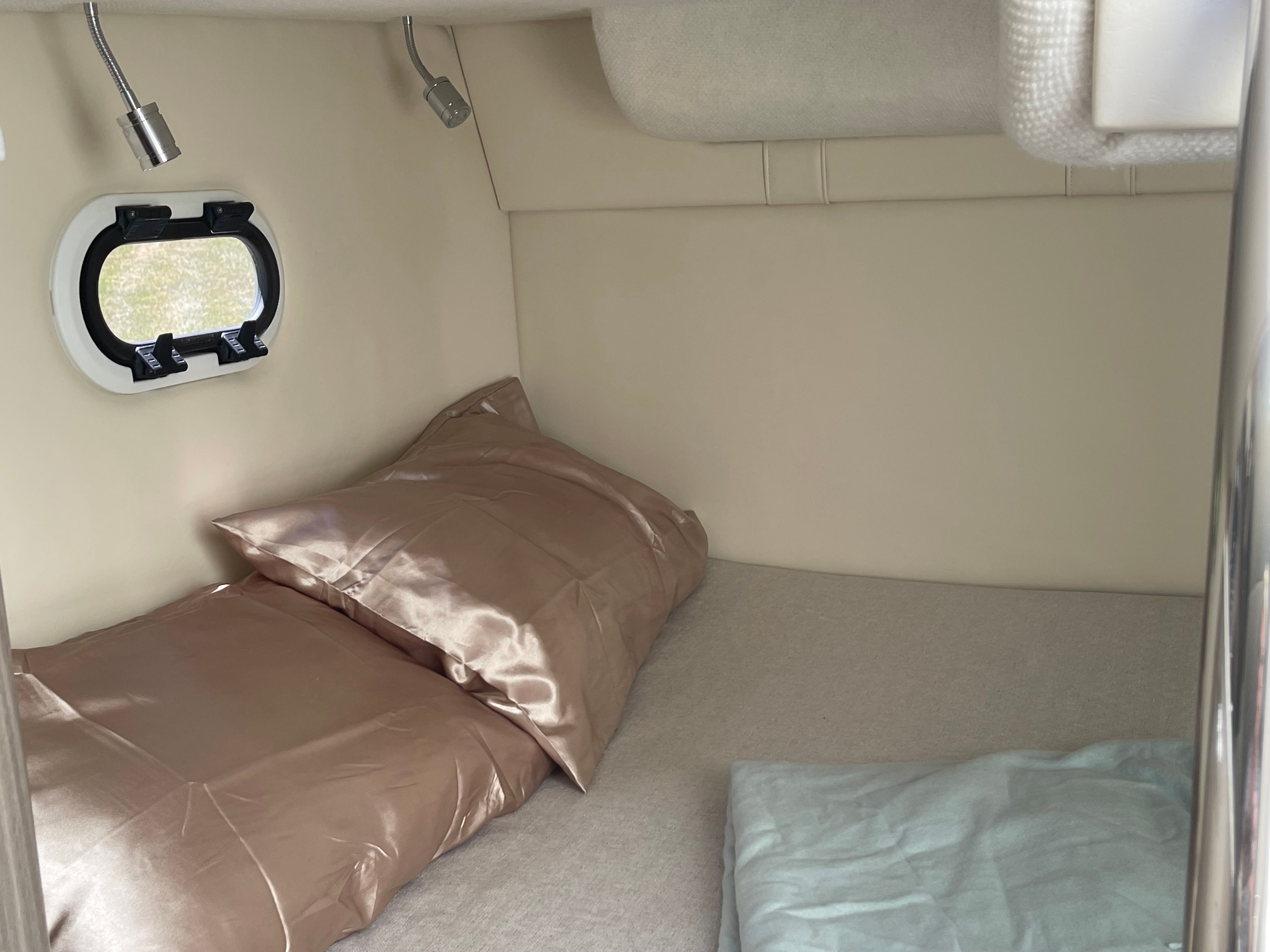 Interior of 2022 Regal 26 Express with bed and window.