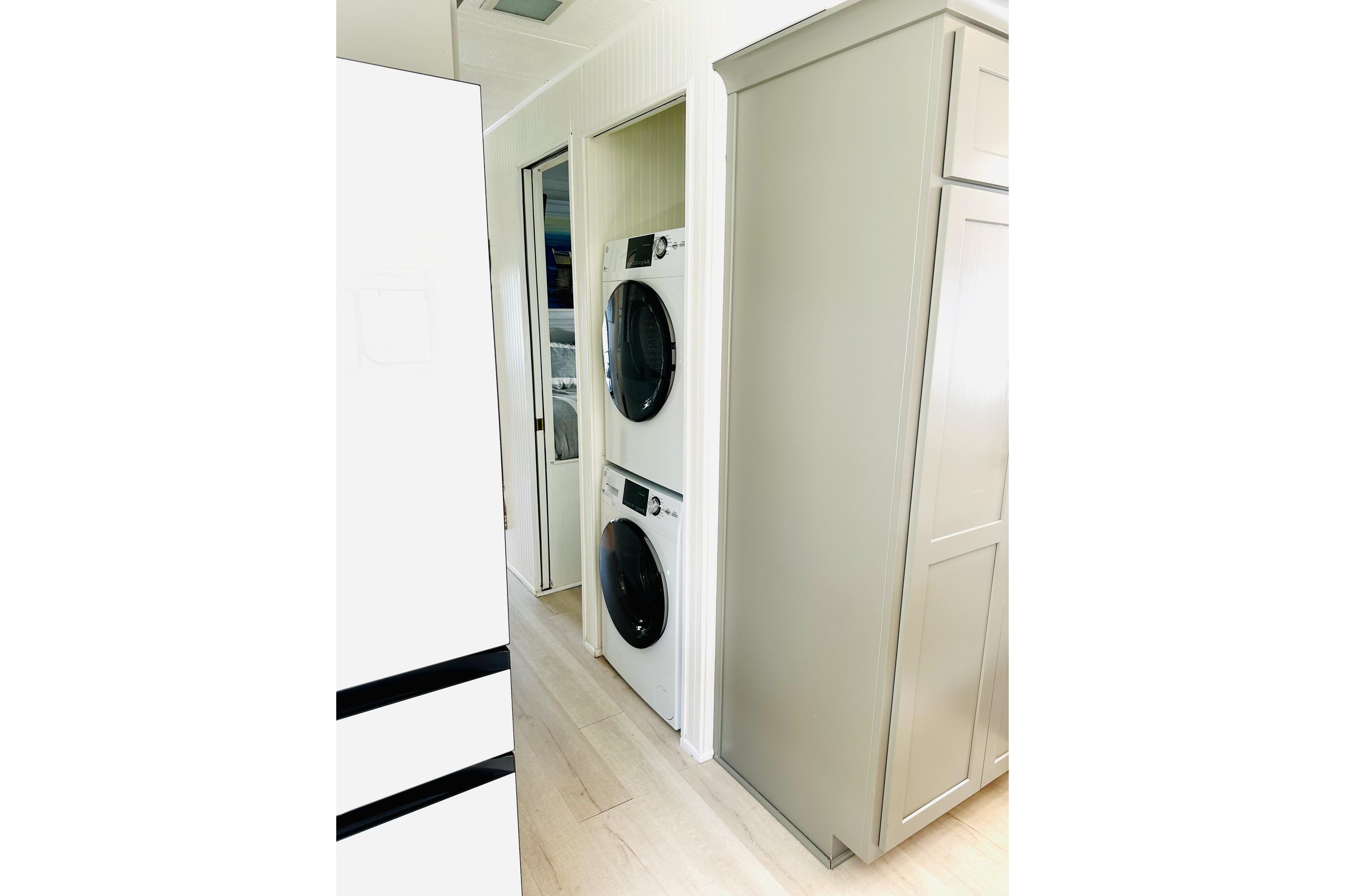 Laundry area with stacked washer and dryer in a 1992 Sumerset 66 houseboat.
