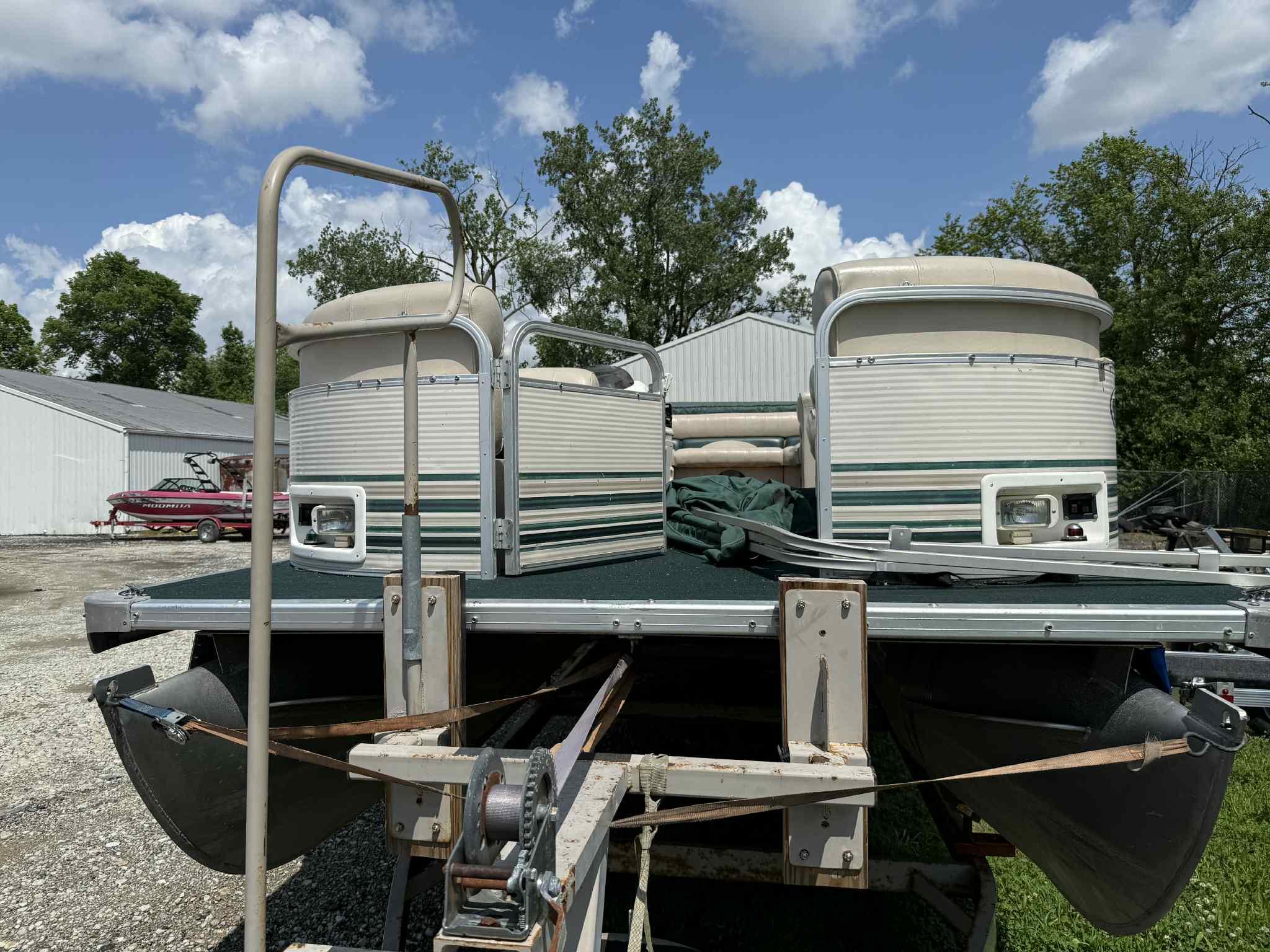 1999 Smoker Craft 8526 Pleasure Isle I/O pontoon boat on trailer, outdoors.