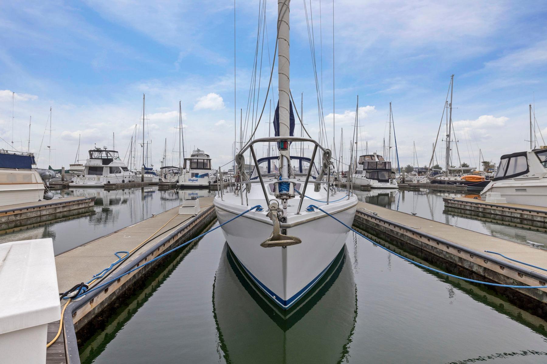 2004 Catalina 36 MkII sailboat docked in a marina under a clear blue sky.