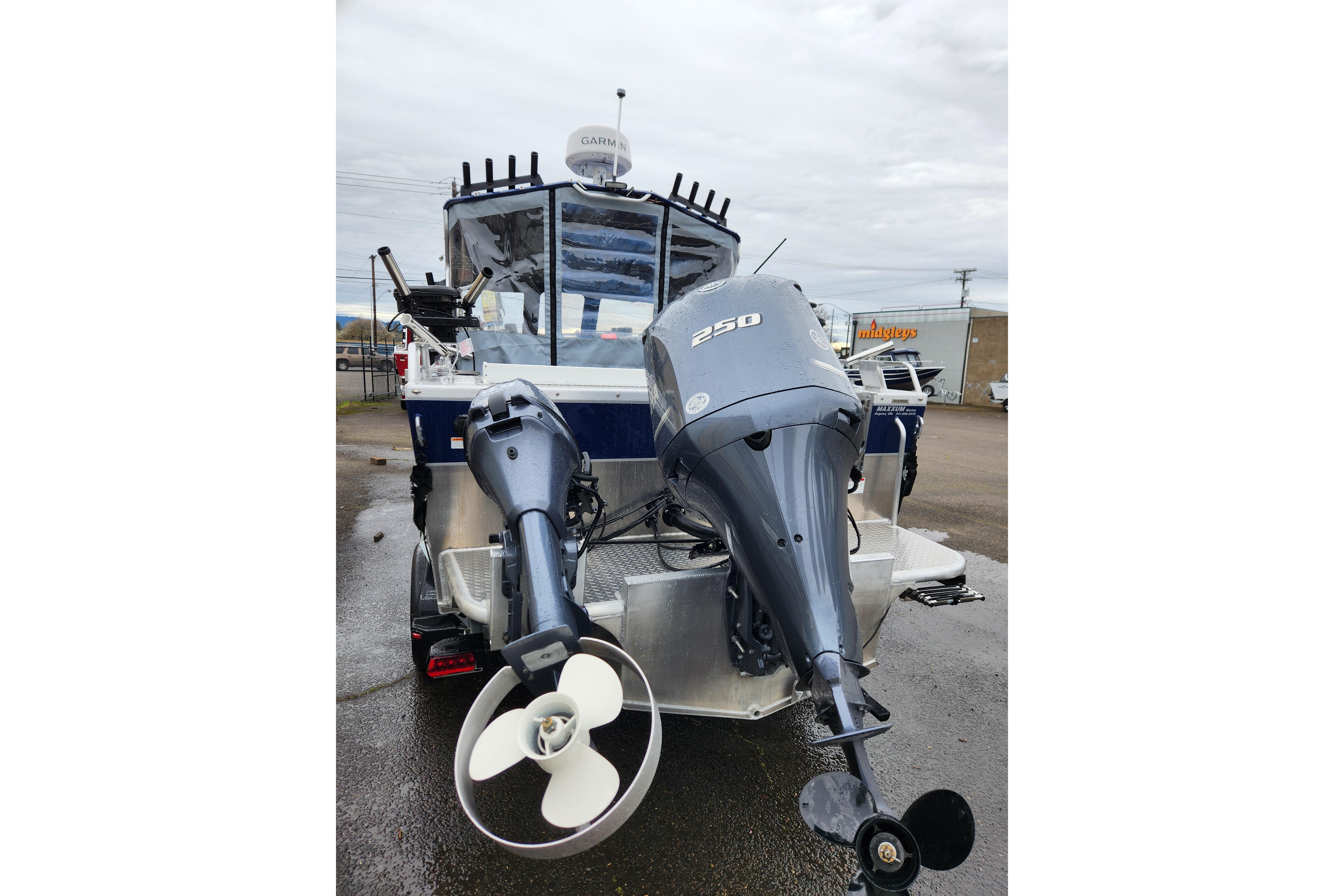 2025 Thunder Jet 21 Chinook OS boat with dual outboard motors, parked outdoors.