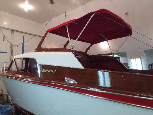 A 1959 Owens Flagship with a red canopy in a garage.