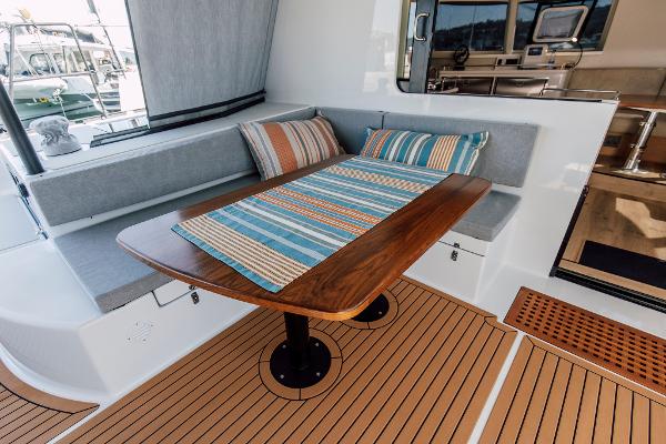 Modern Vision 444 yacht interior with cozy seating and striped cushions, 2026 model.