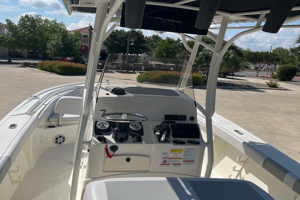 2026 Mako 214 Center Console boat interior with steering wheel and control panel.