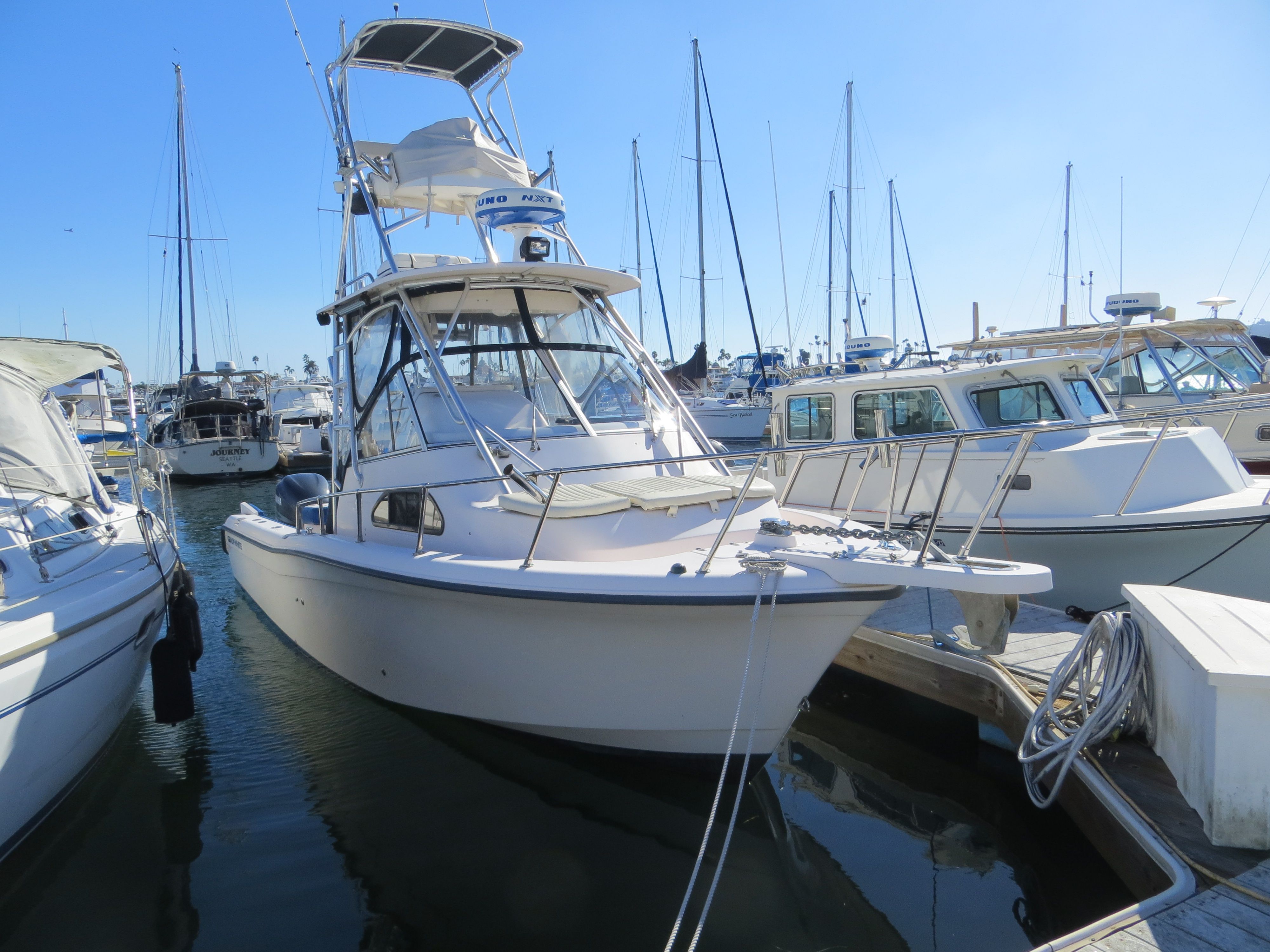 2007 Grady-White Sailfish 282 docked in a marina, surrounded by other boats.