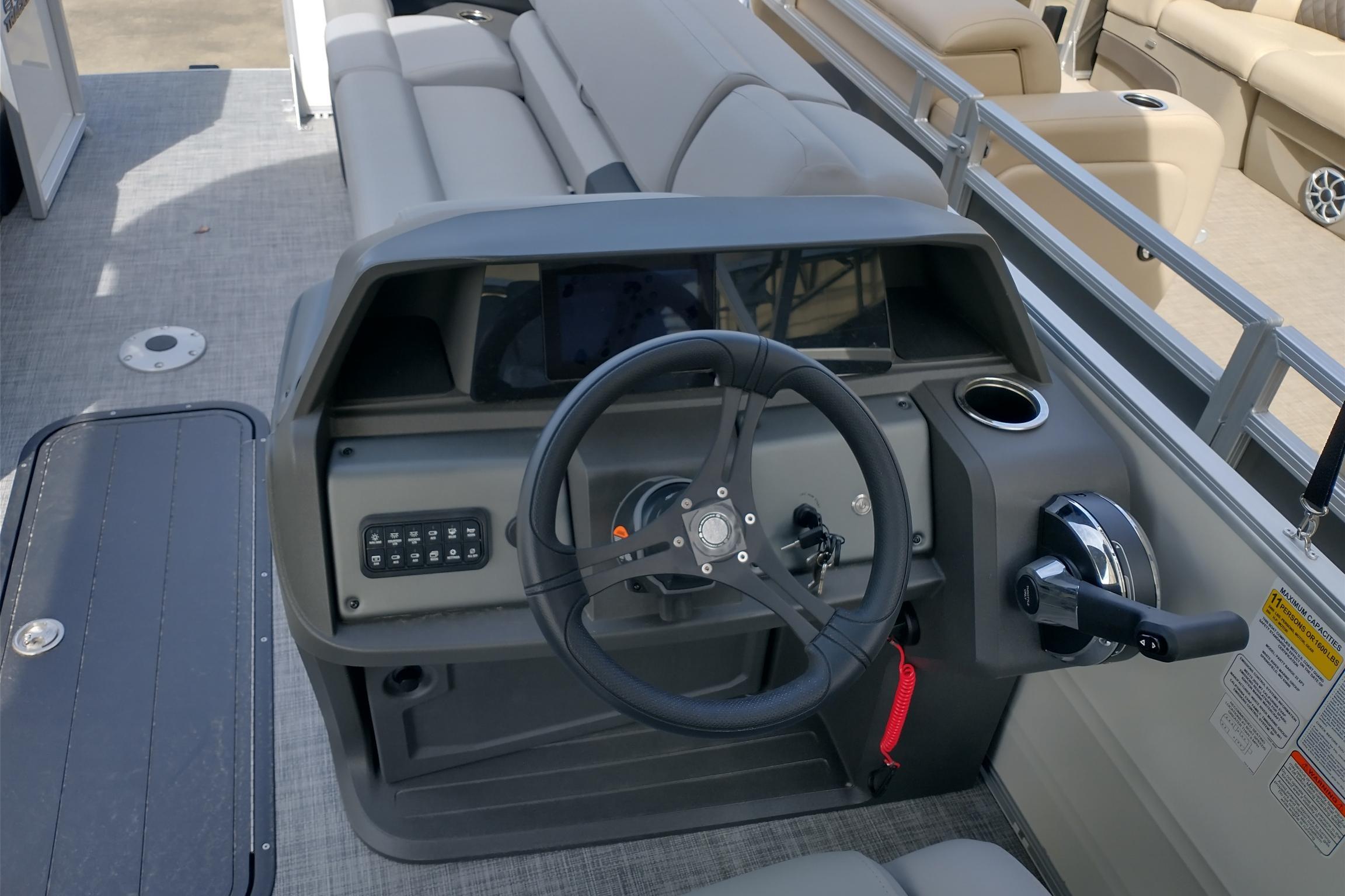 2026 Sun Tracker Party Barge 22 XP3 steering console with controls and seating.