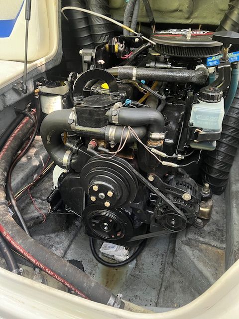 Engine compartment of a 2007 Bayliner 185 boat with visible engine.