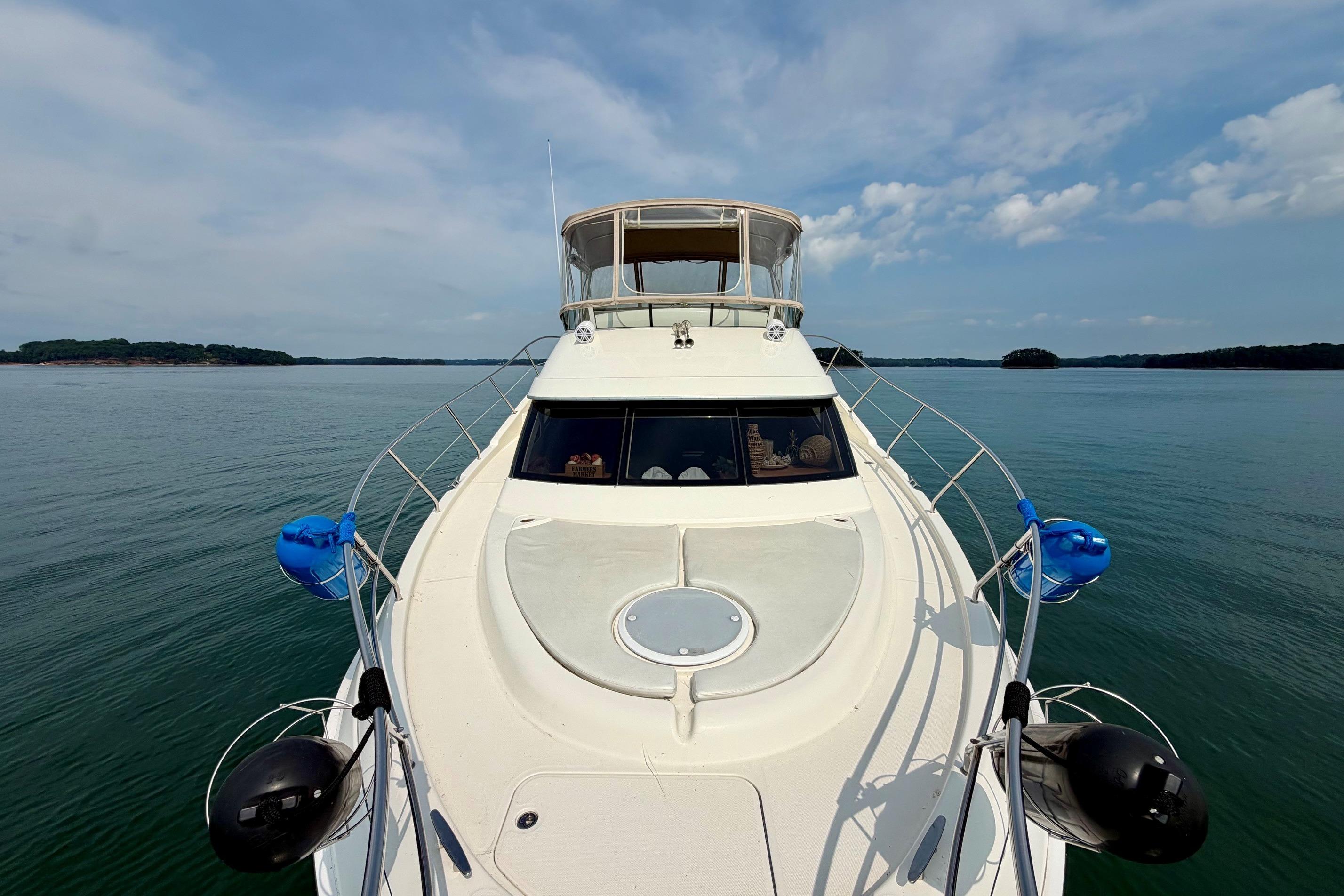2004 Silverton 39 Motor Yacht cruising on calm waters under a clear sky.