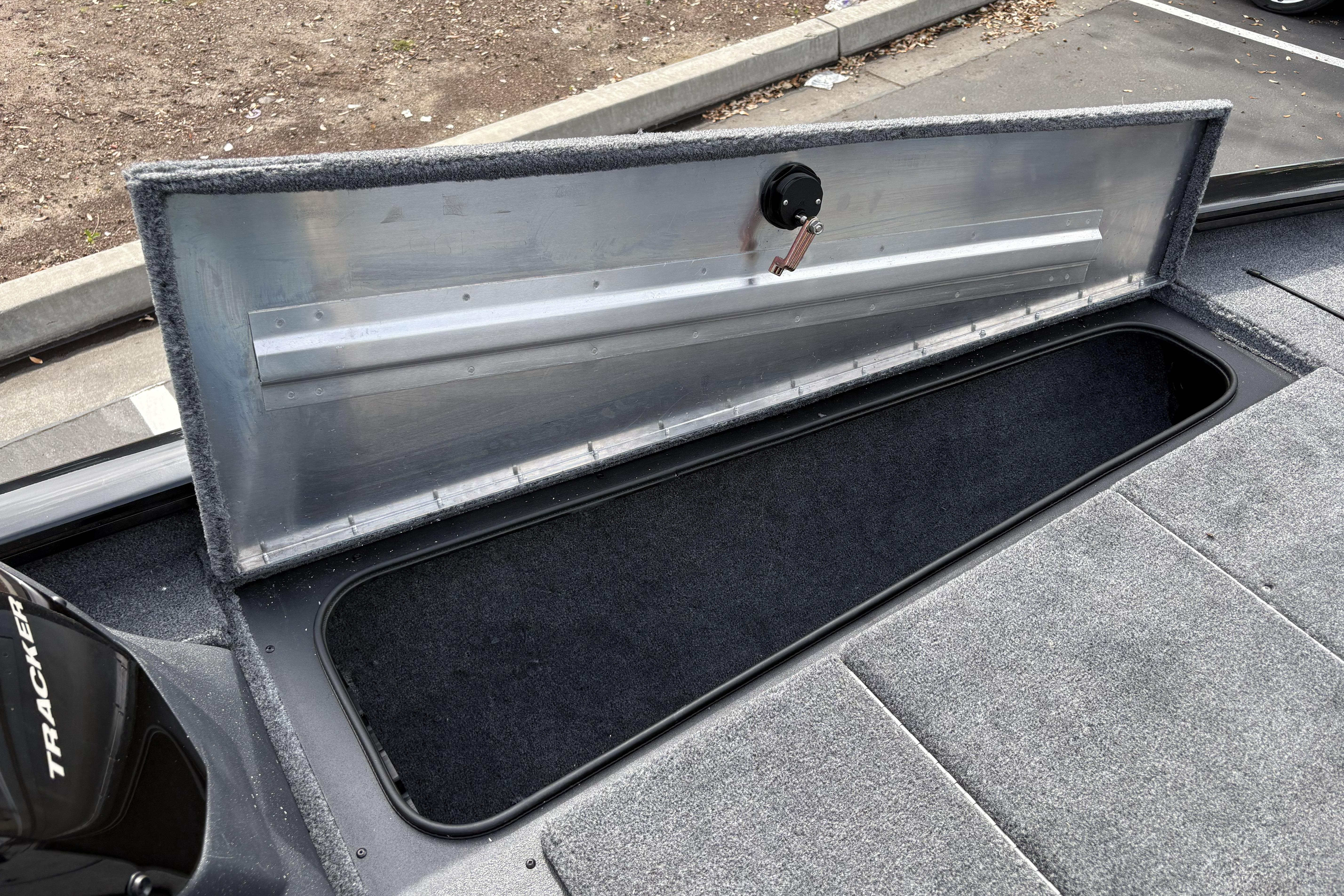Open storage compartment on 2026 Tracker Pro Team 195 boat, showcasing interior space.