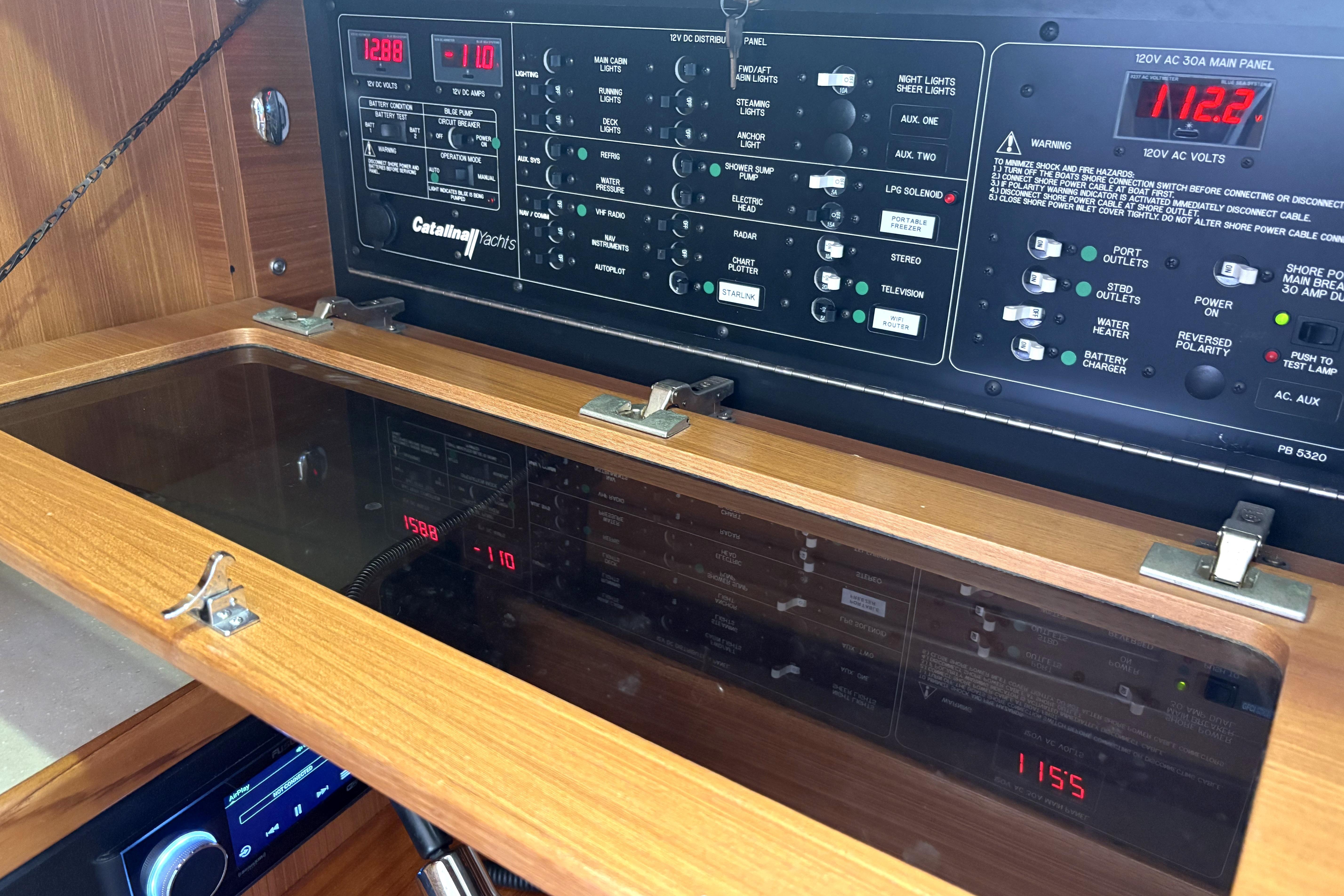 Electrical control panel of a 2011 Catalina 355 yacht, featuring various switches and displays.