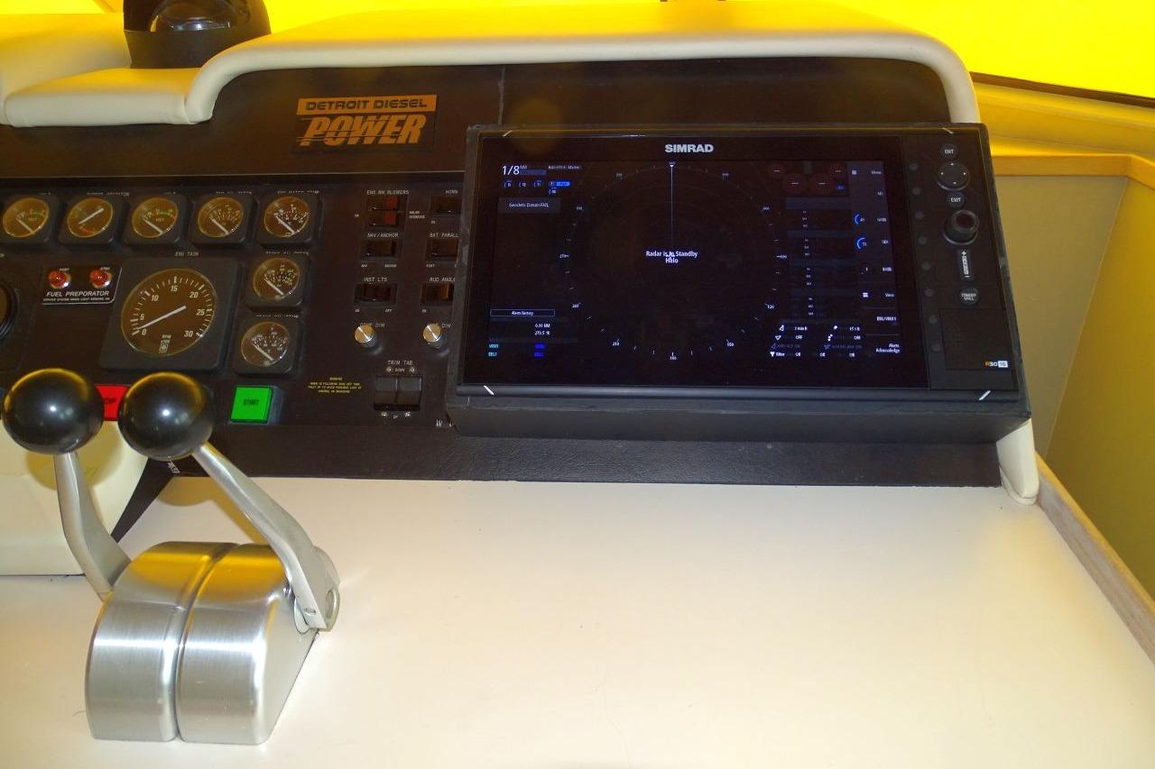 Control panel of a 1991 Hatteras 61 Motor Yacht with navigation equipment.