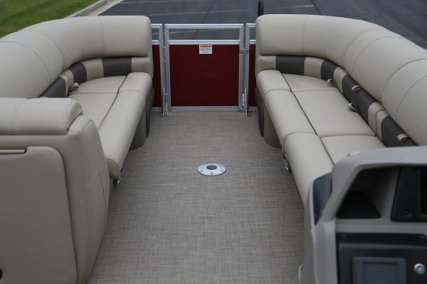 2024 Sun Tracker Party Barge 24 DLX interior with beige seating and spacious layout.