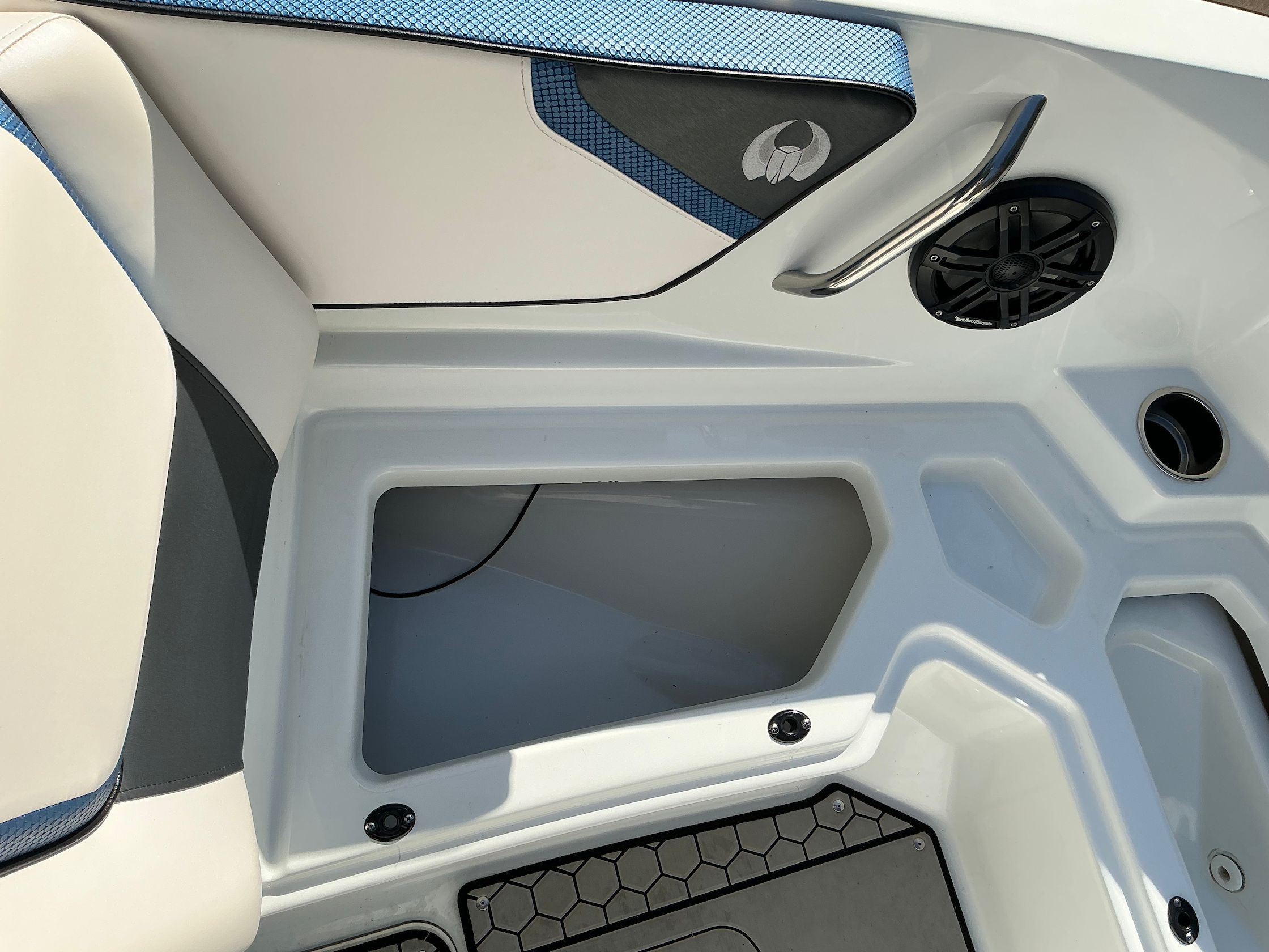 Interior of a 2021 Scarab 215 ID boat with speaker and storage compartment.