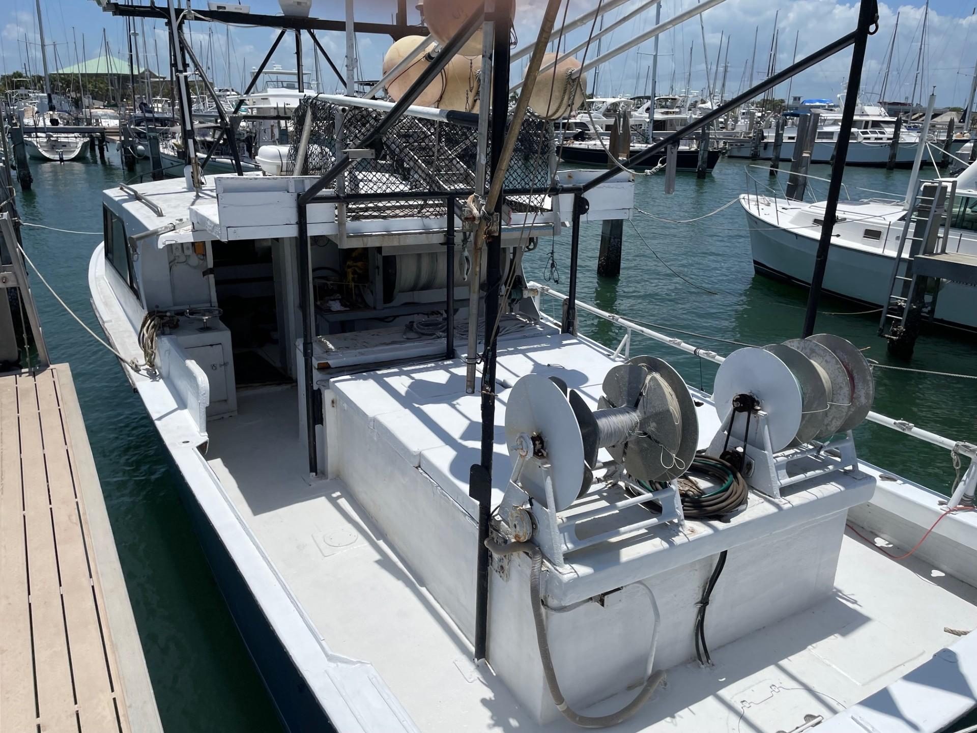 Commercial fishing boat docked at marina, 1983 Hull #1 Key West model.