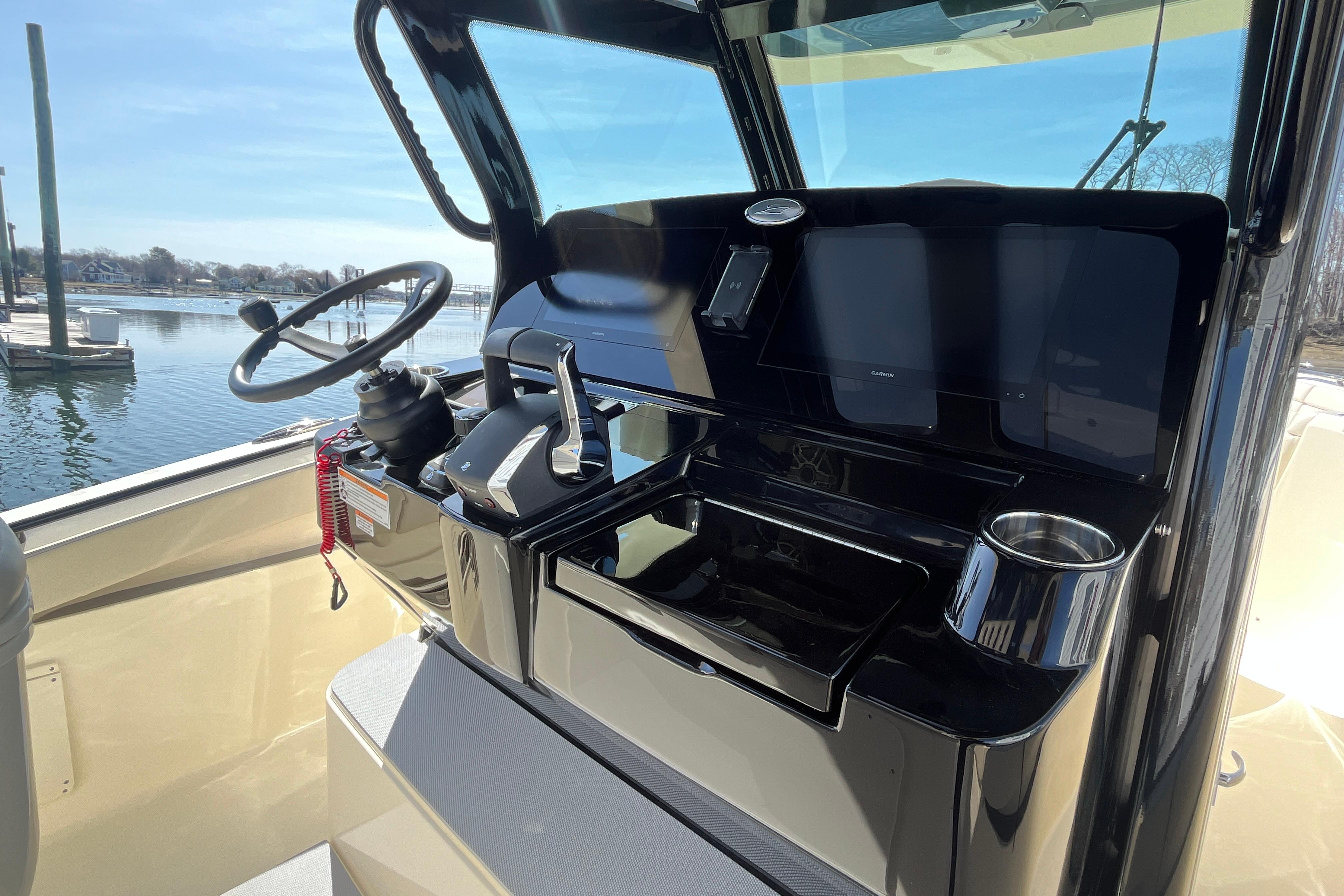 2025 Scout 330 LXF boat helm with steering wheel and control panel.