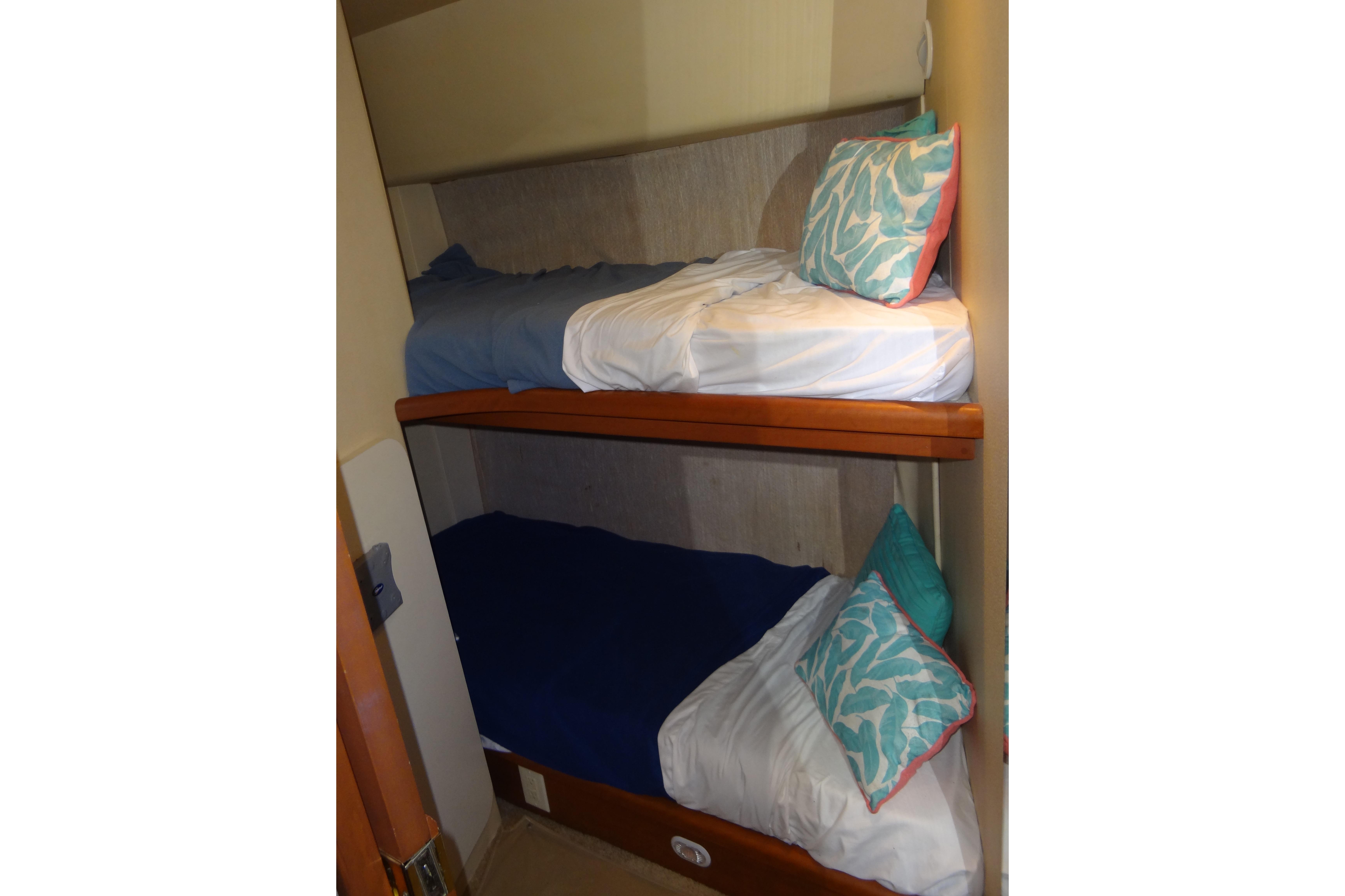 Bunk beds in 2005 Silverton 34 Convertible yacht cabin with colorful pillows.