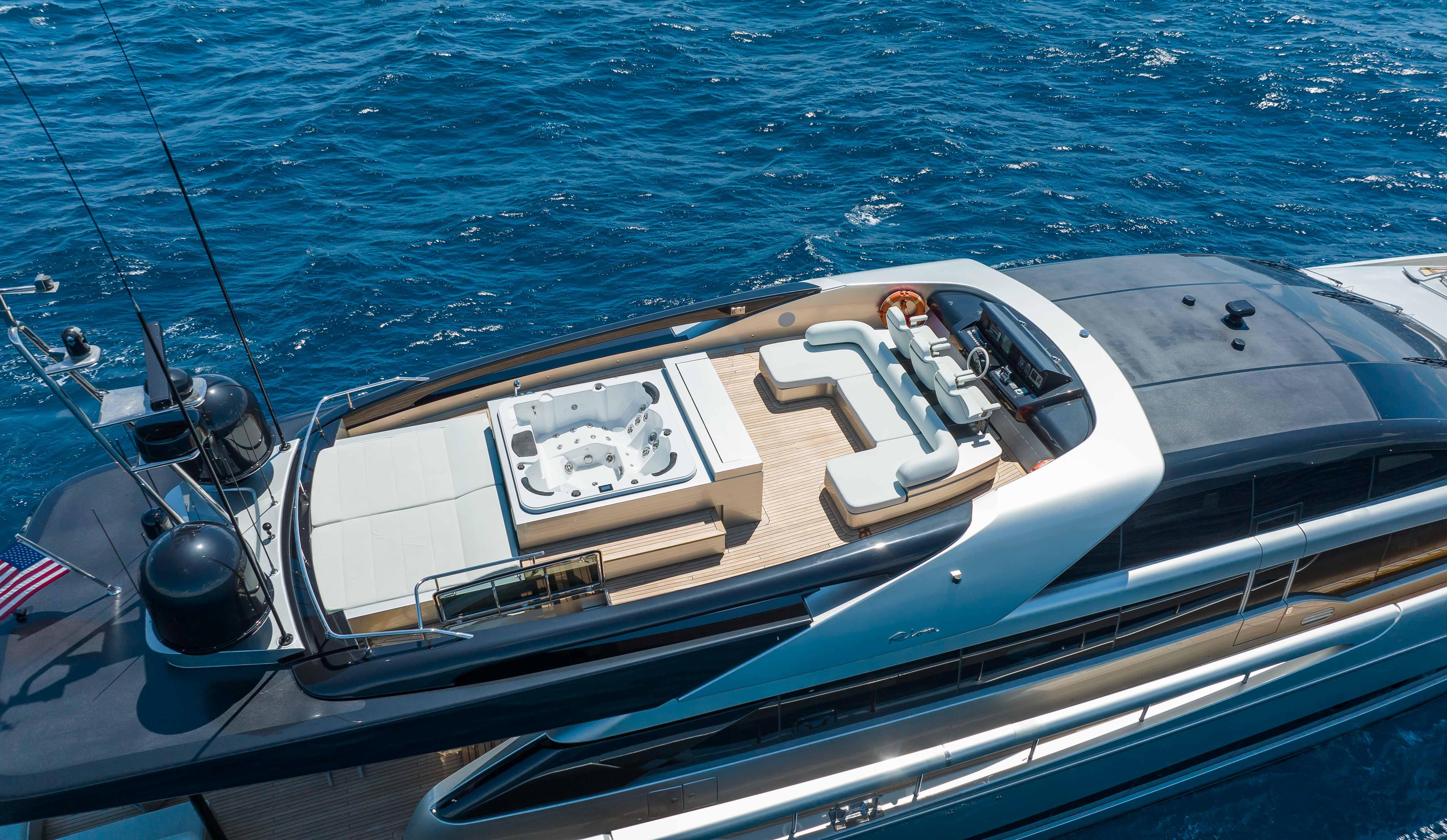 Luxurious 2014 Riva Mythos Motoryacht with spacious deck and jacuzzi, cruising on blue ocean waters.
