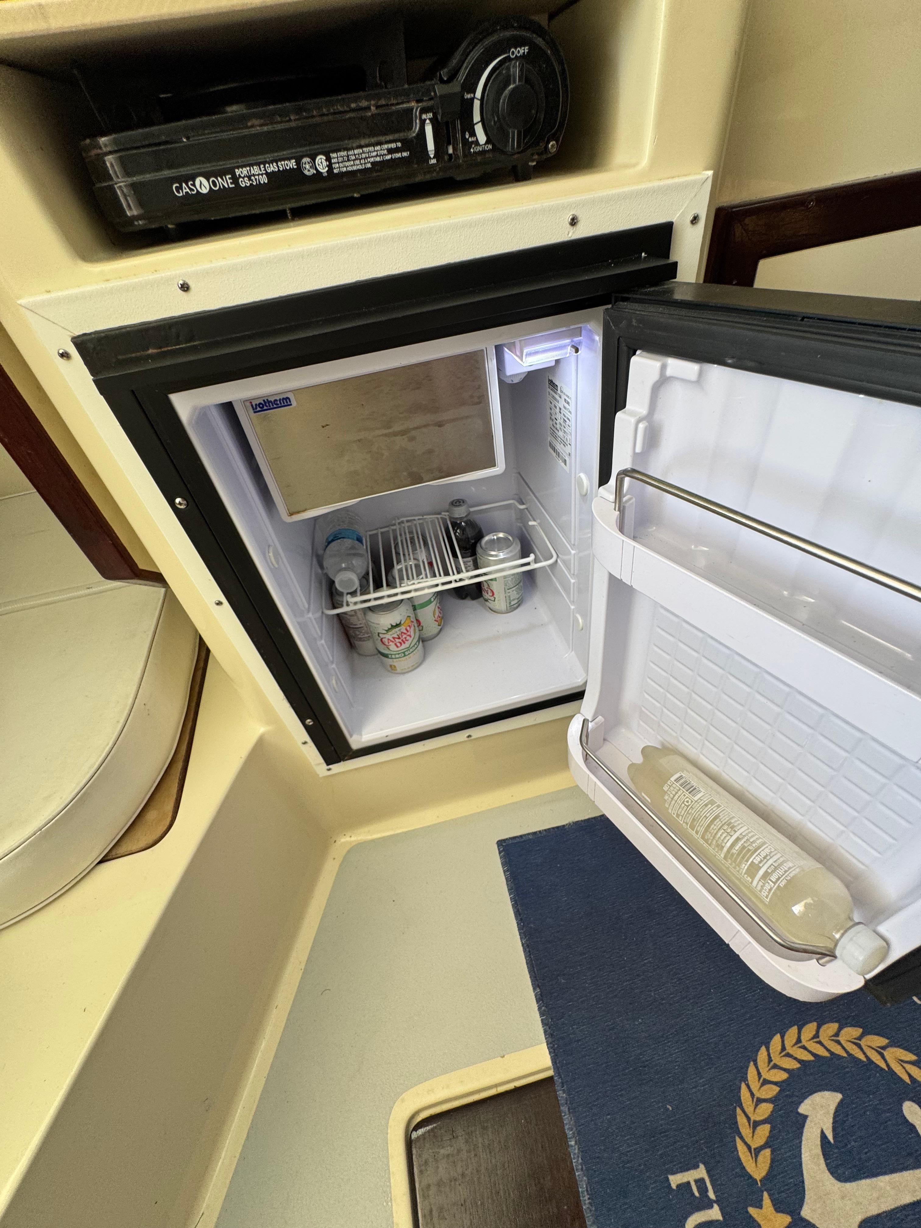 Mini fridge inside a 1996 Albin Tournament Express boat, stocked with drinks.