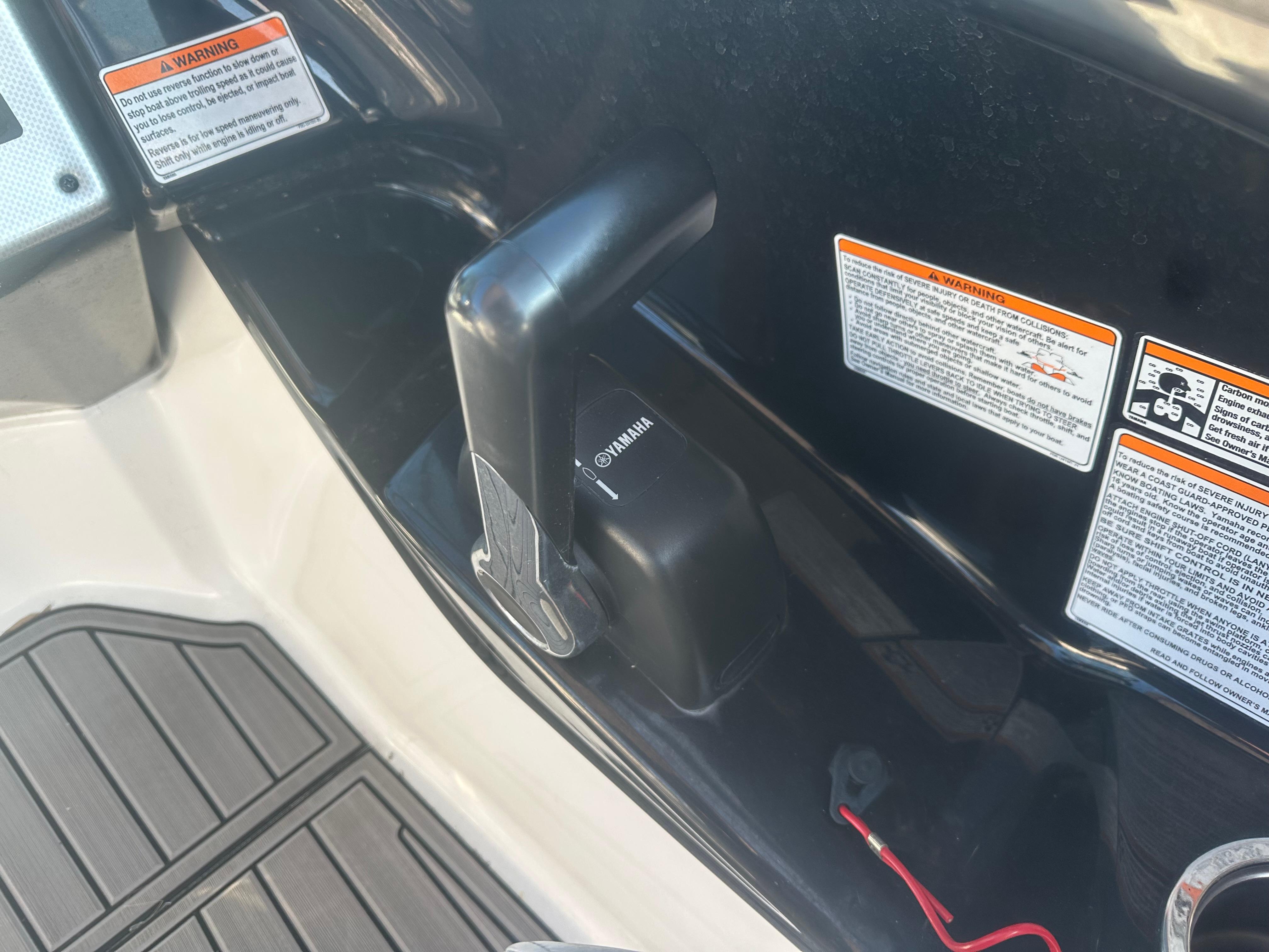 Close-up of 2013 Yamaha SX192 boat throttle control with safety warnings.