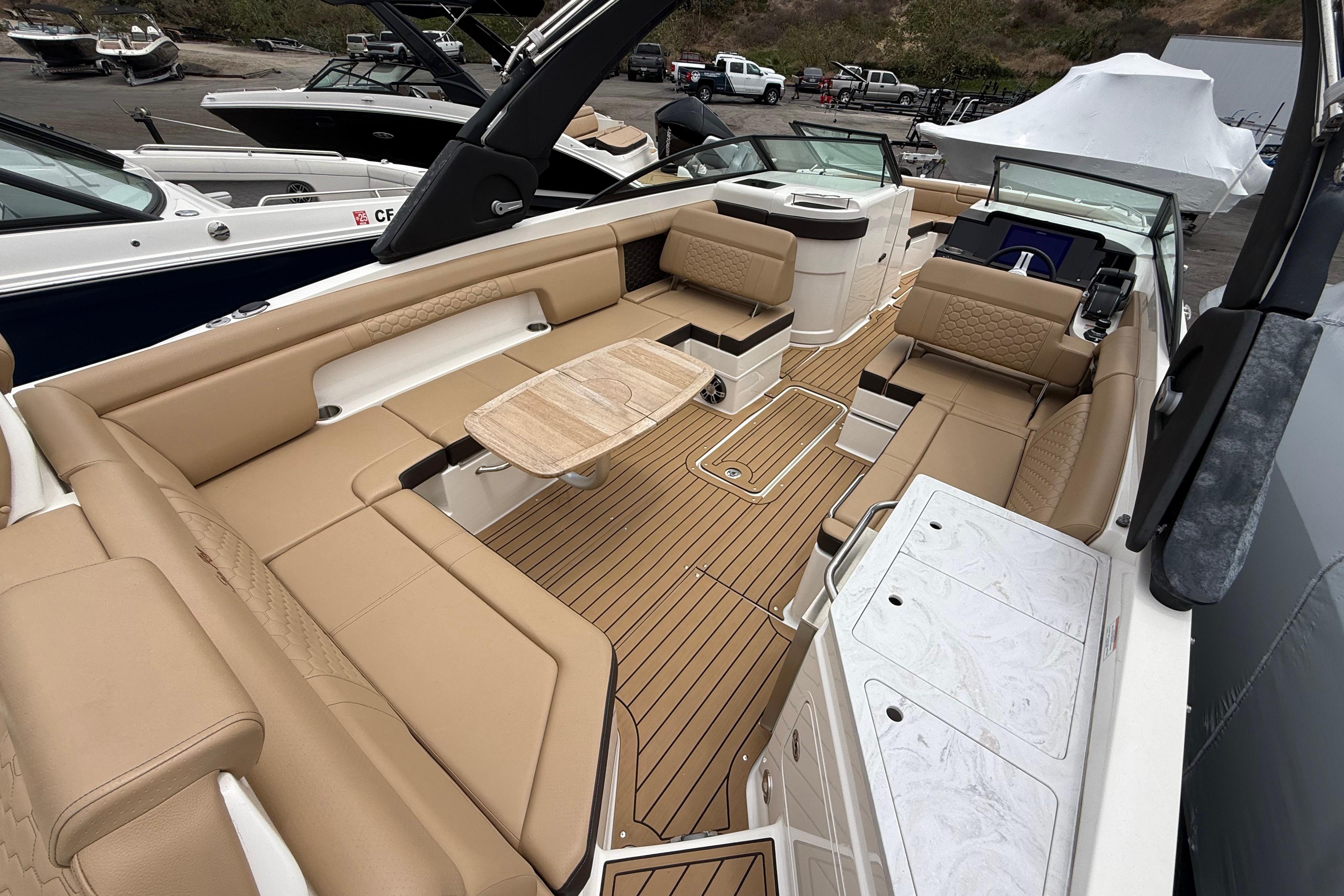 2022 Sea Ray SDX 290 Outboard boat interior with tan seating and wooden deck.
