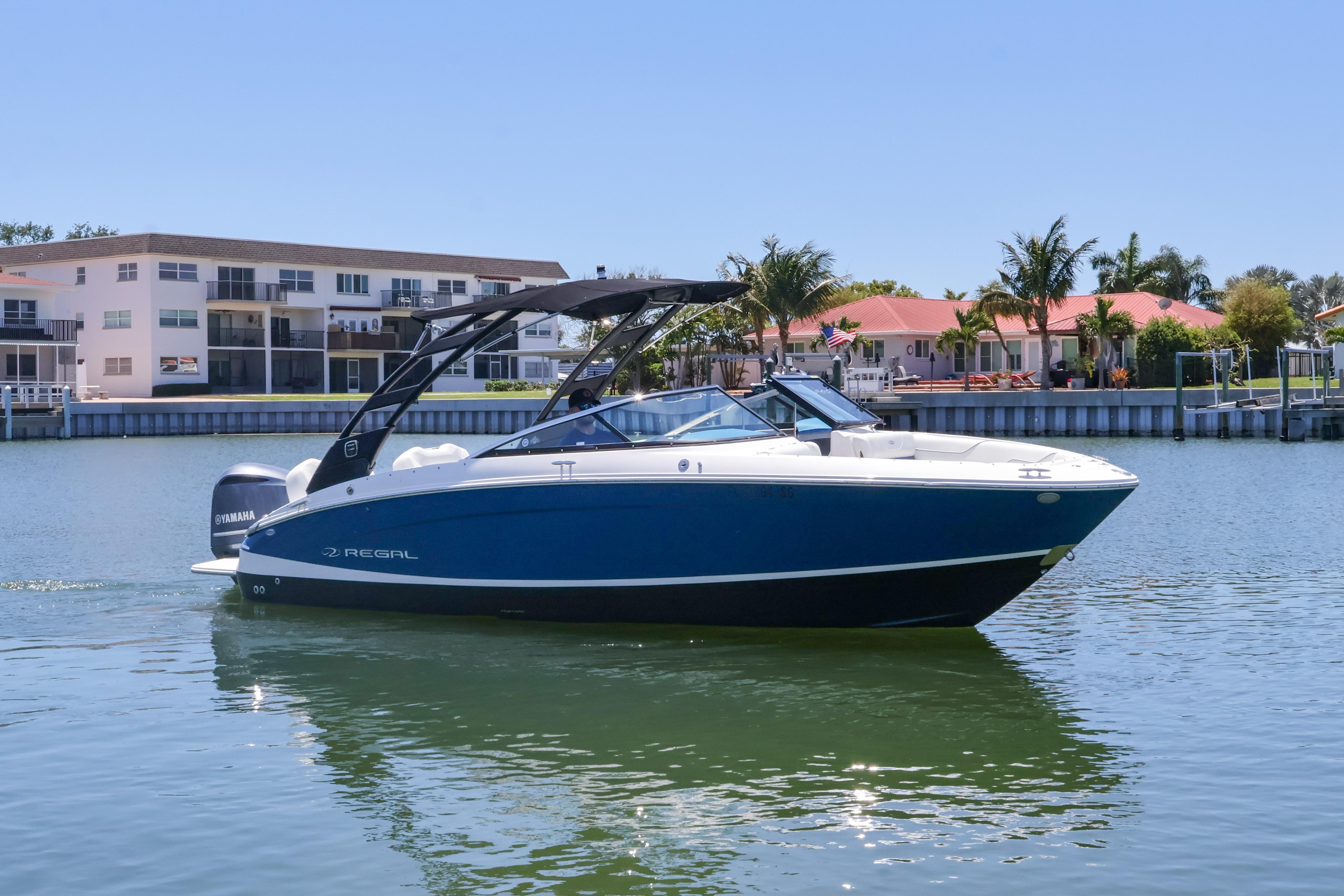 2020 Regal LX4 boat on calm water near waterfront homes.