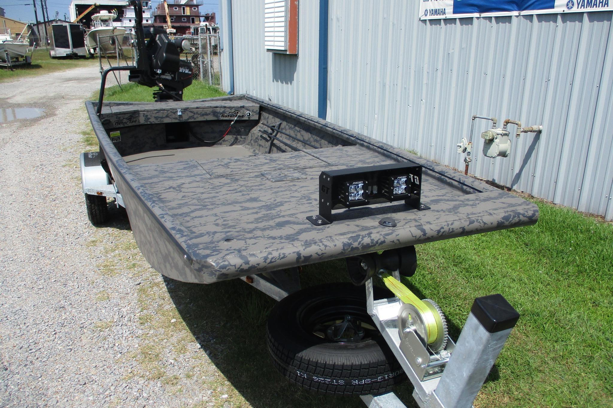 2026 Gator Tail 1754 Extreme boat on trailer, parked outdoors near a metal building.