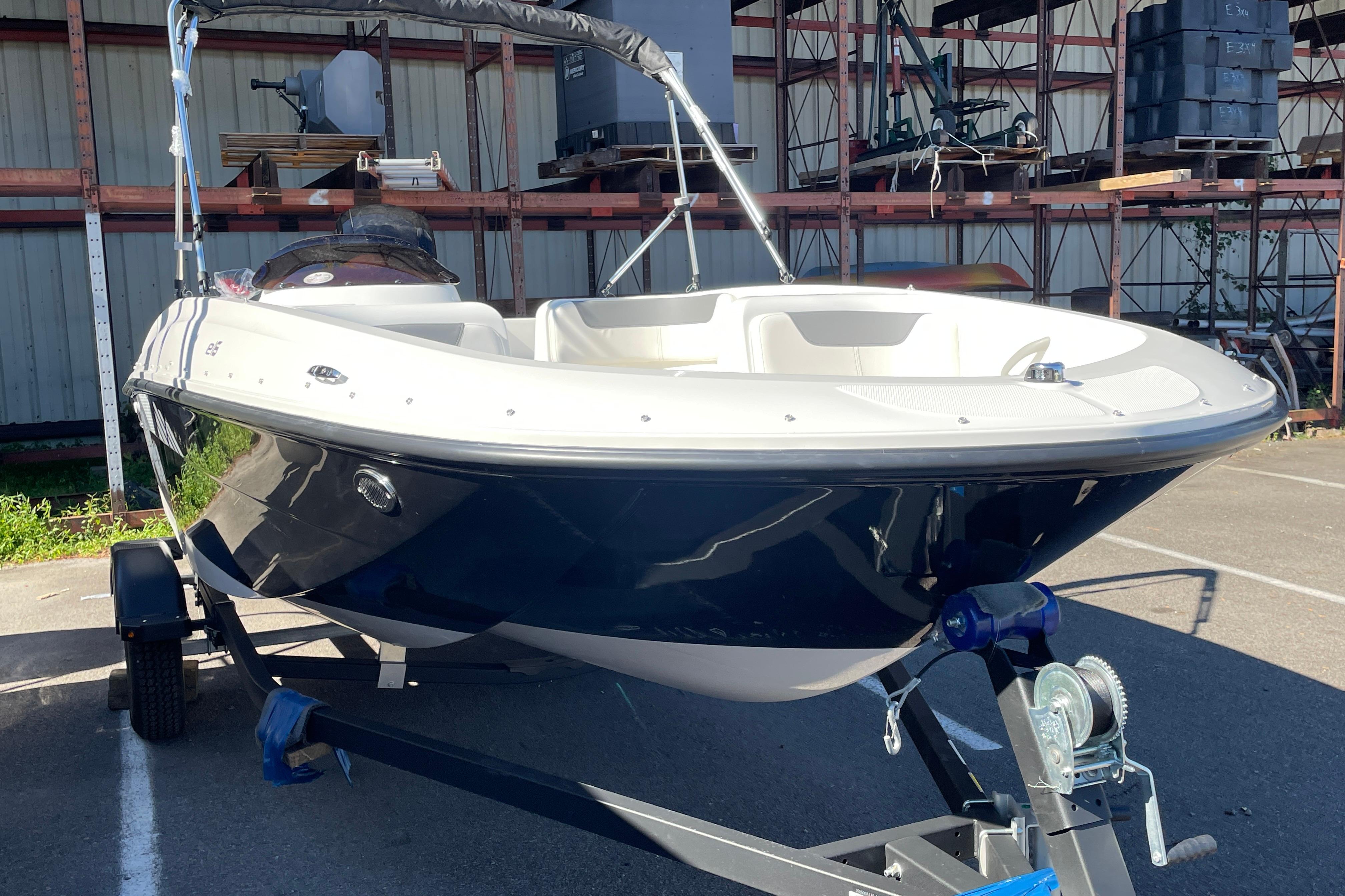 2026 Bayliner Element E16 boat on trailer in storage facility.