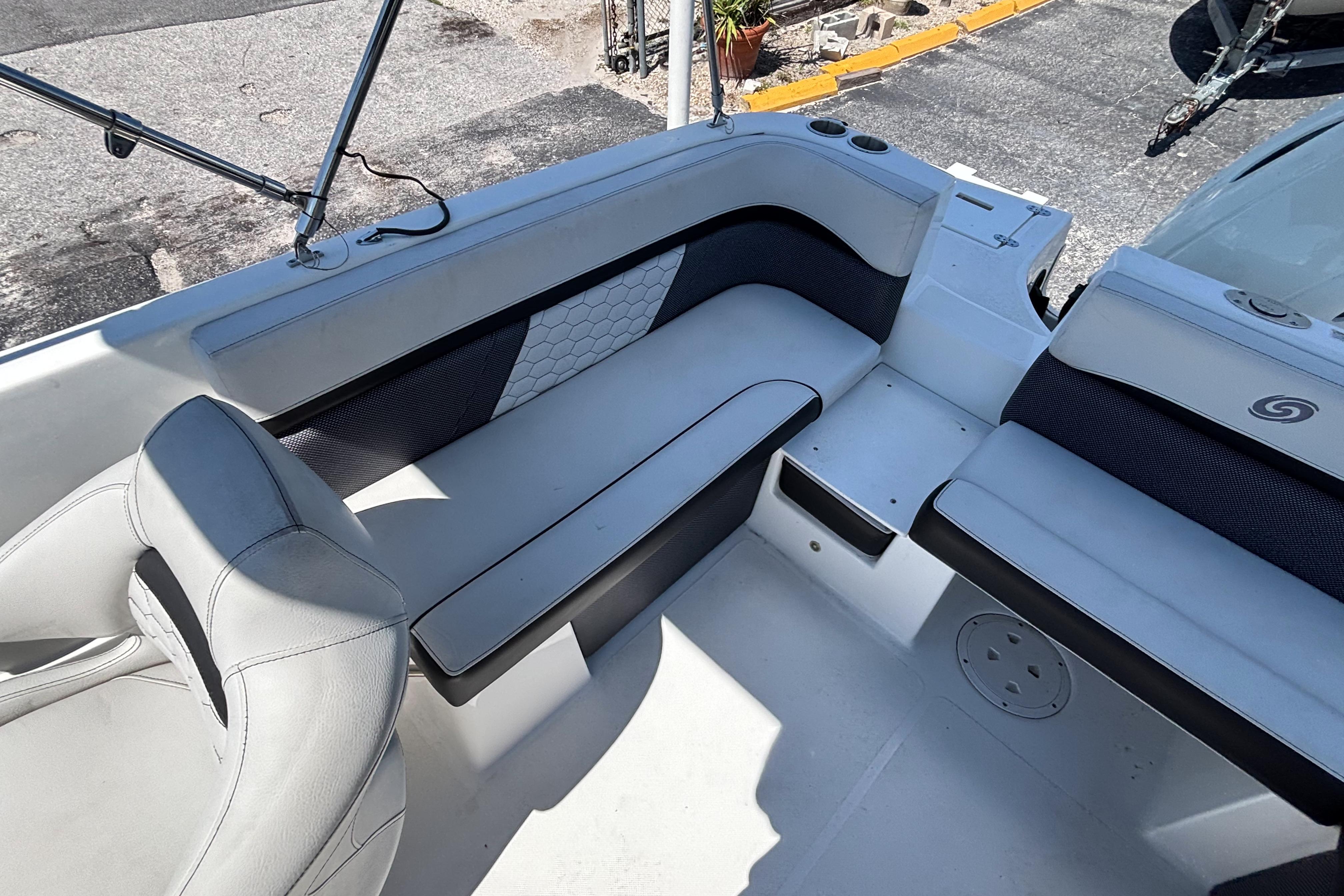 2019 Hurricane Sundeck Sport 218 OB boat interior with cushioned seating and cup holders.