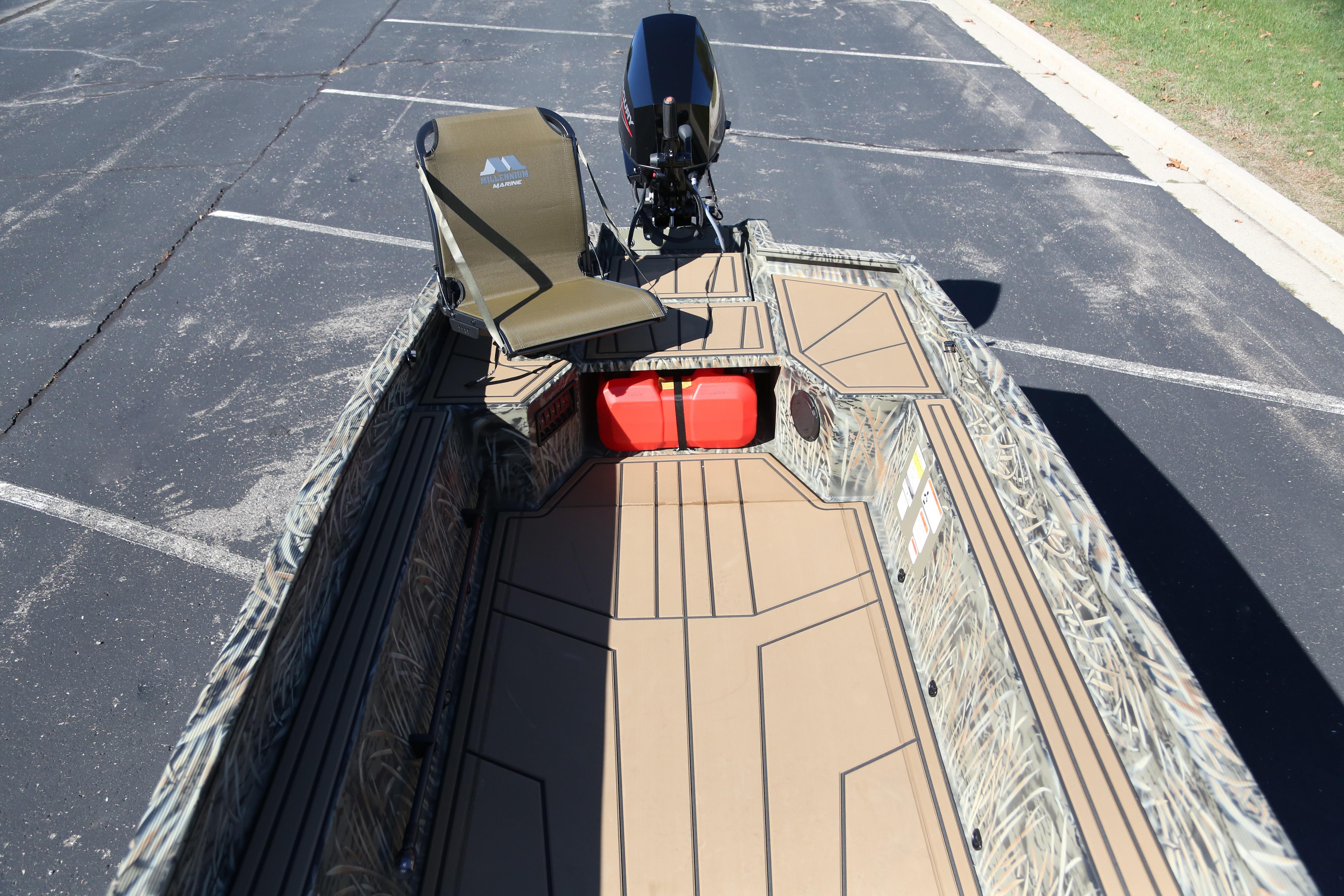 2026 Tracker Grizzly 1650 T Prairie Wings Edition boat with camouflage design and seating.