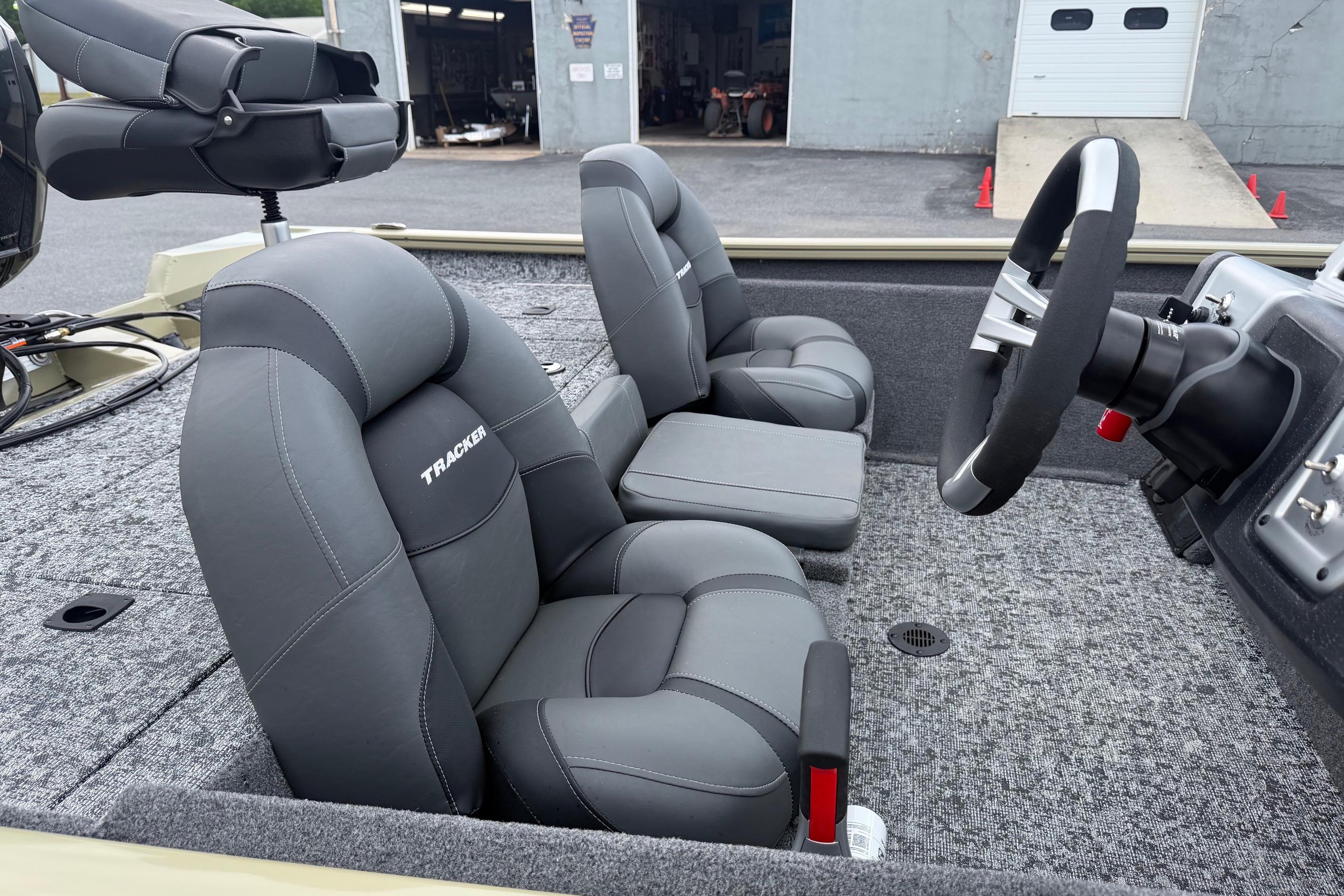 2026 Tracker Pro Team 195 boat interior with gray seats and steering wheel.