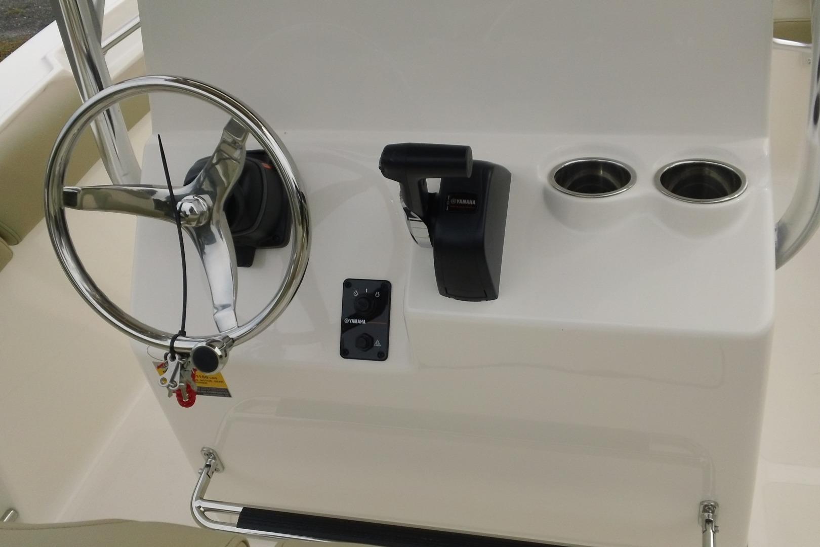 2026 Pioneer 202 Islander boat console with steering wheel and controls.