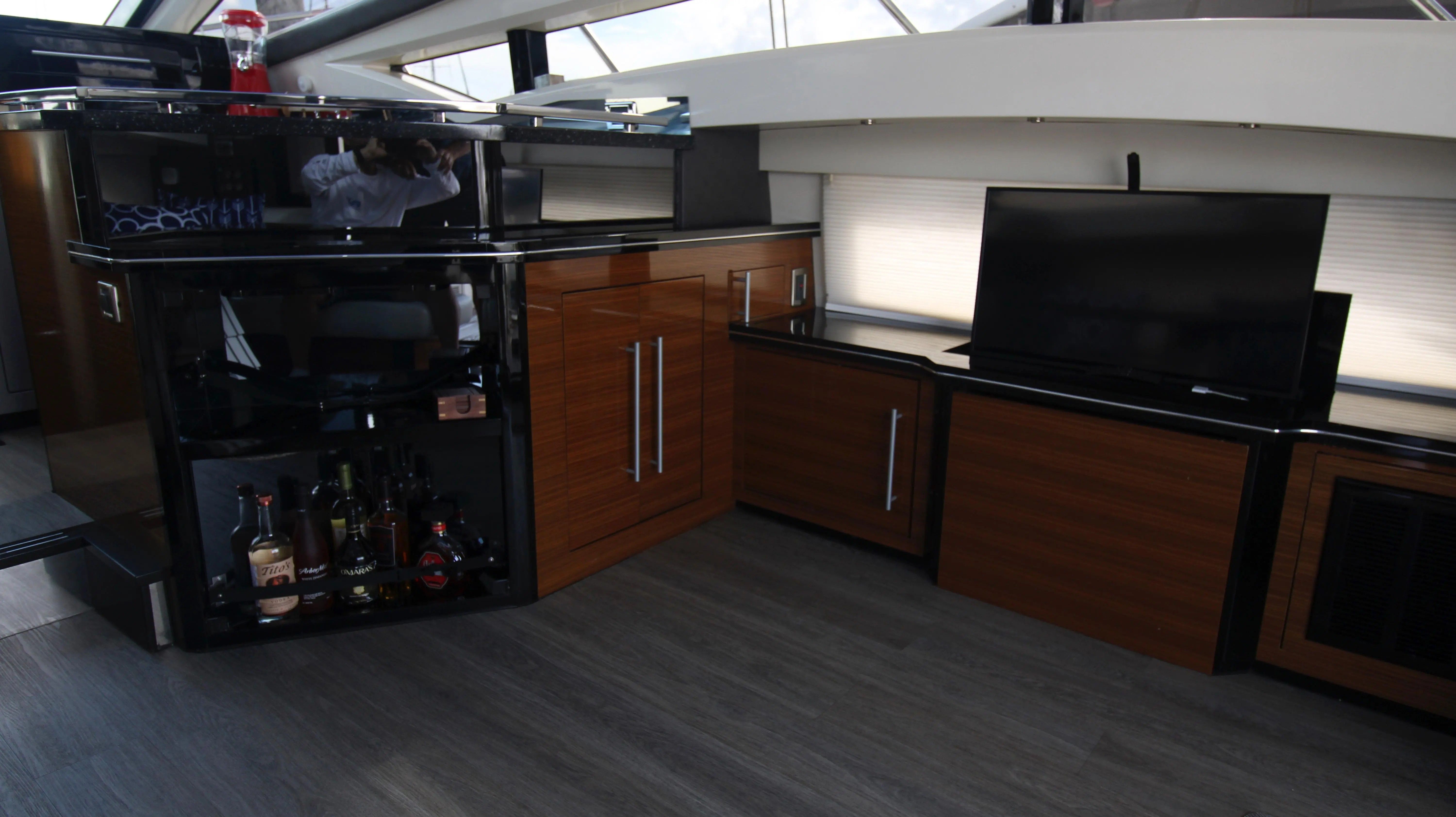 Interior of a 2010 Marquis Sport Coupe with sleek wood paneling and modern entertainment system.