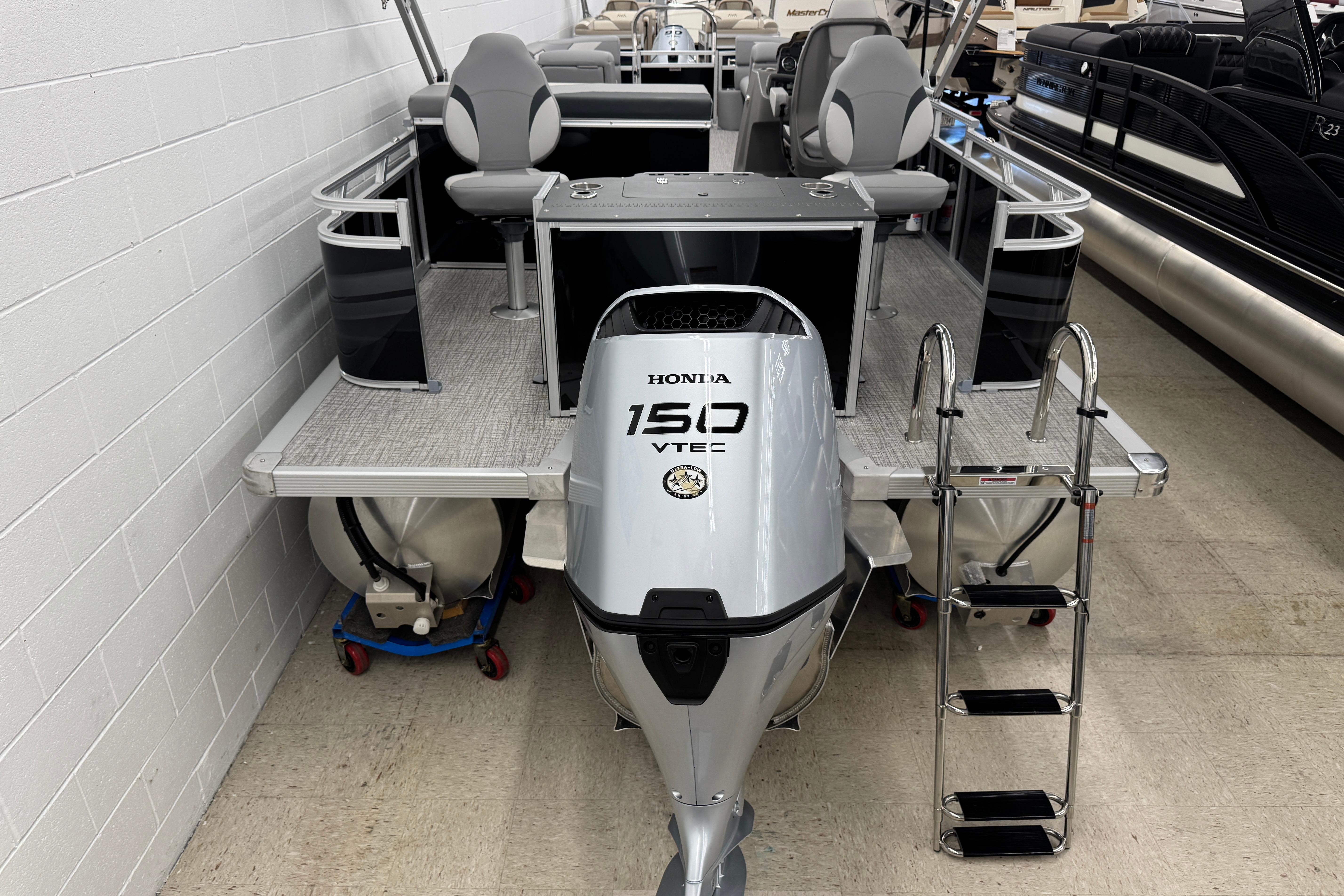 2026 Avalon Ventue 85 RF pontoon boat with Honda 150 VTEC engine, docked indoors.