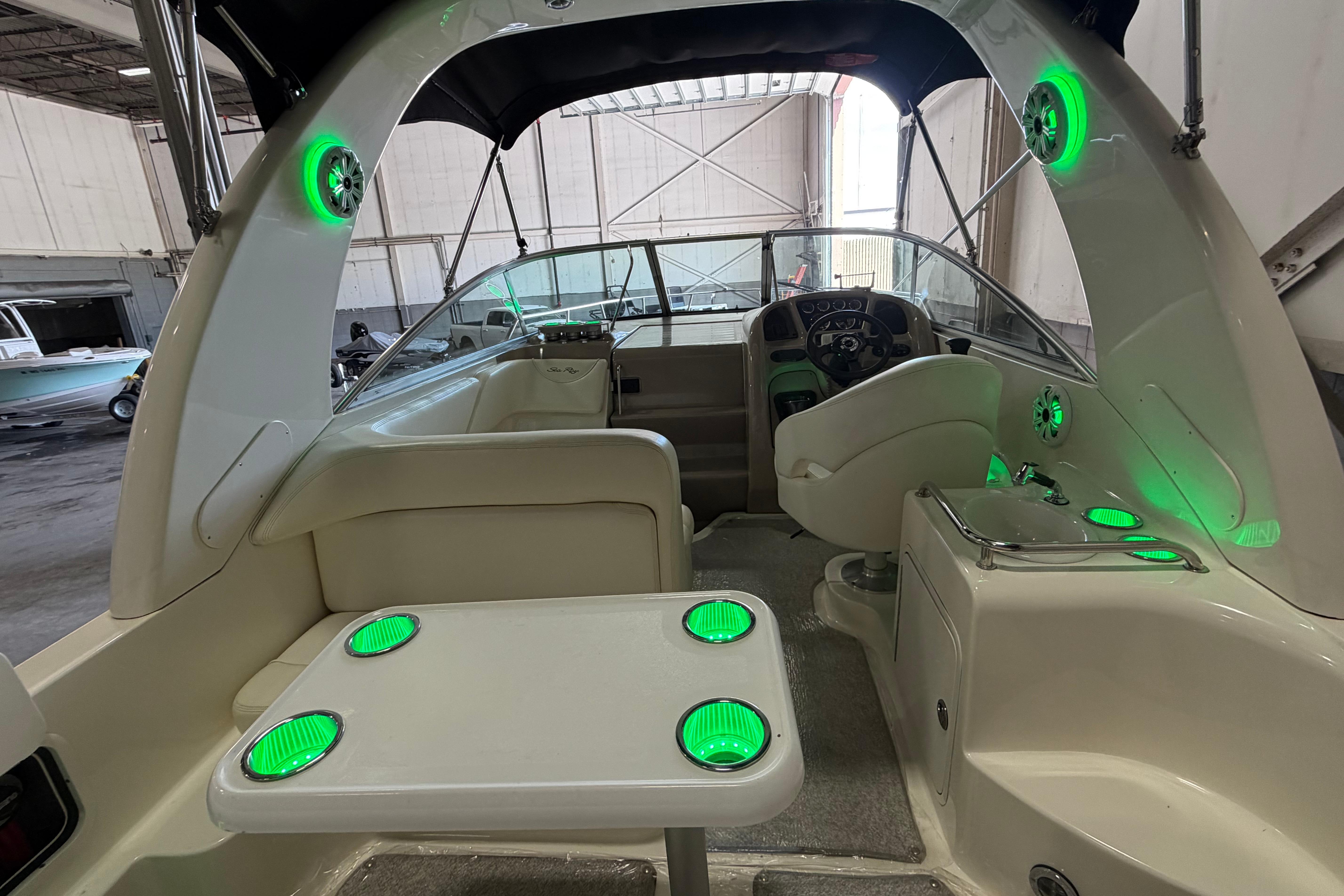 2004 Sea Ray Sundancer 260 boat interior with green LED lights and steering console.