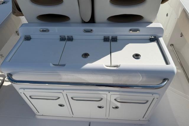 2014 Southport 29 FE boat console with storage compartments and cushioned seating.