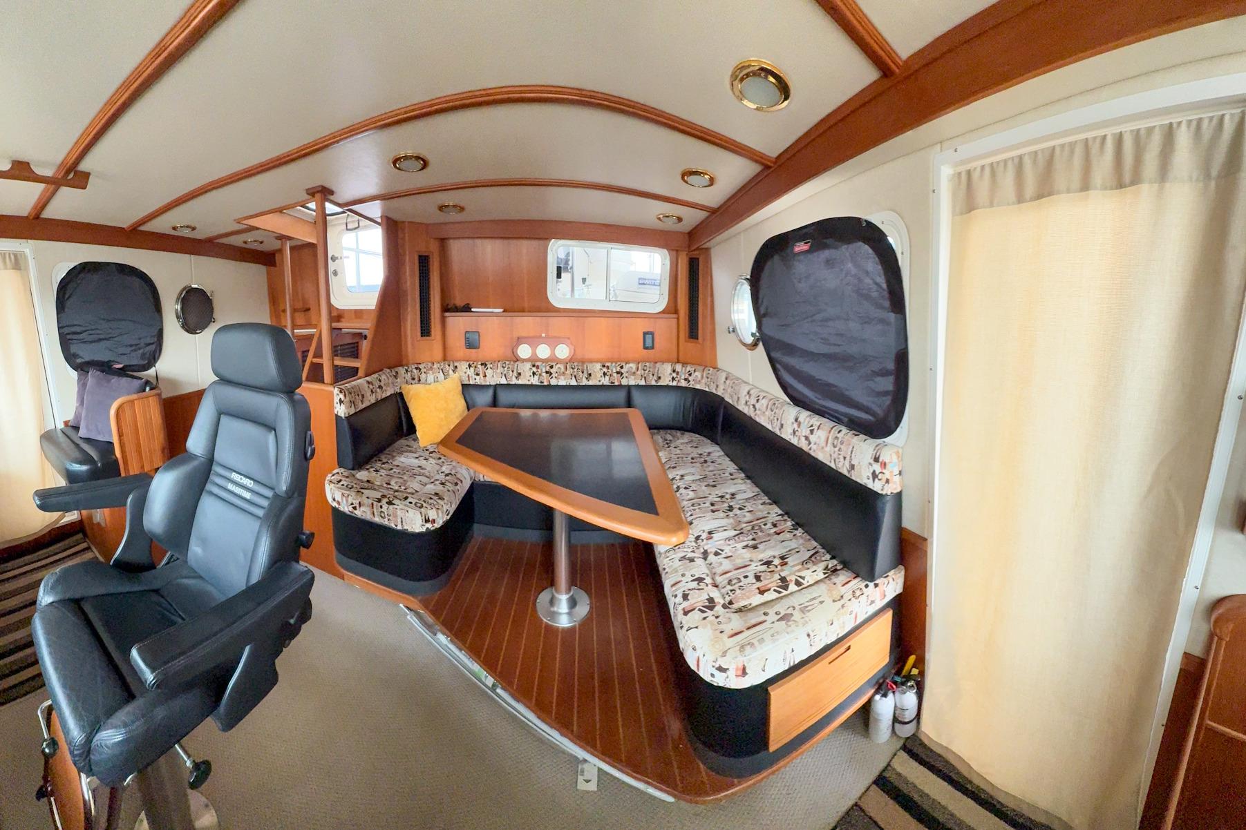 Luxurious 2007 Nordic Tug 54 interior with plush seating and elegant wood finishes.