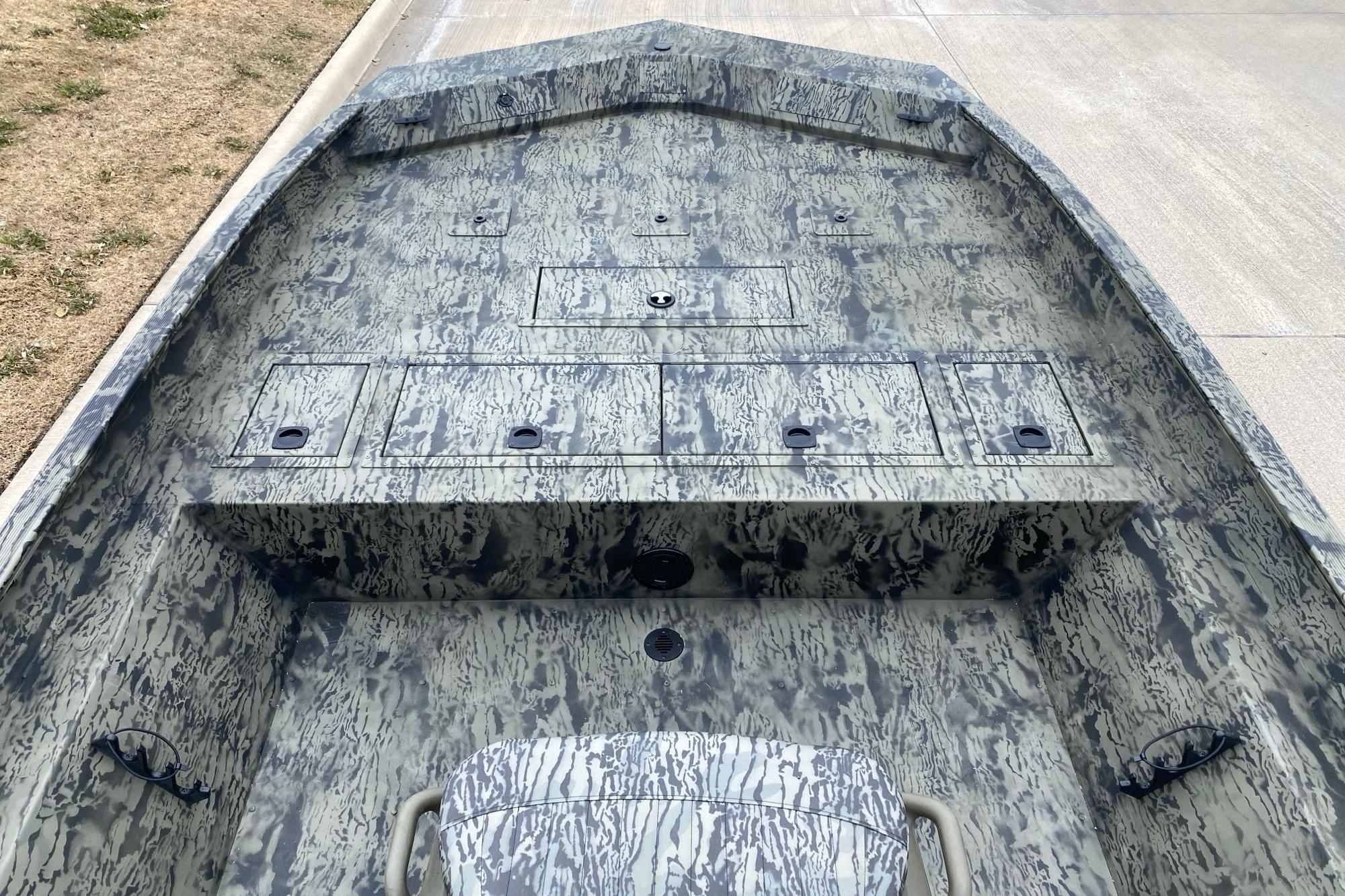 2026 Tracker Grizzly 2072 CC boat interior with camouflage design and storage compartments.